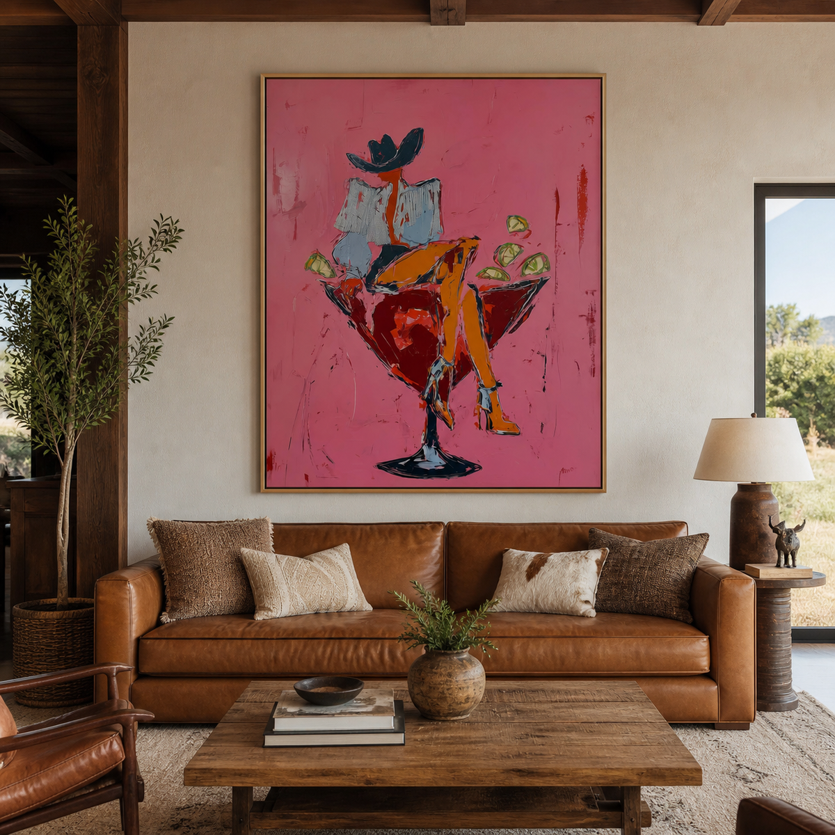 Cocktail cowgirl wall art with a hat-wearing woman seated in a red martini glass displayed above an entryway console.