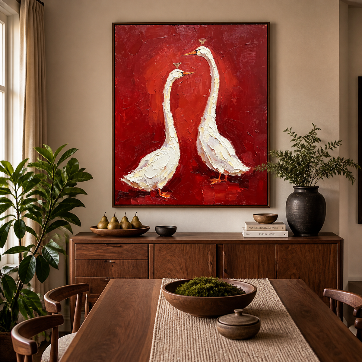 White goose wall art with two birds on a textured red background displayed above a neutral sofa.