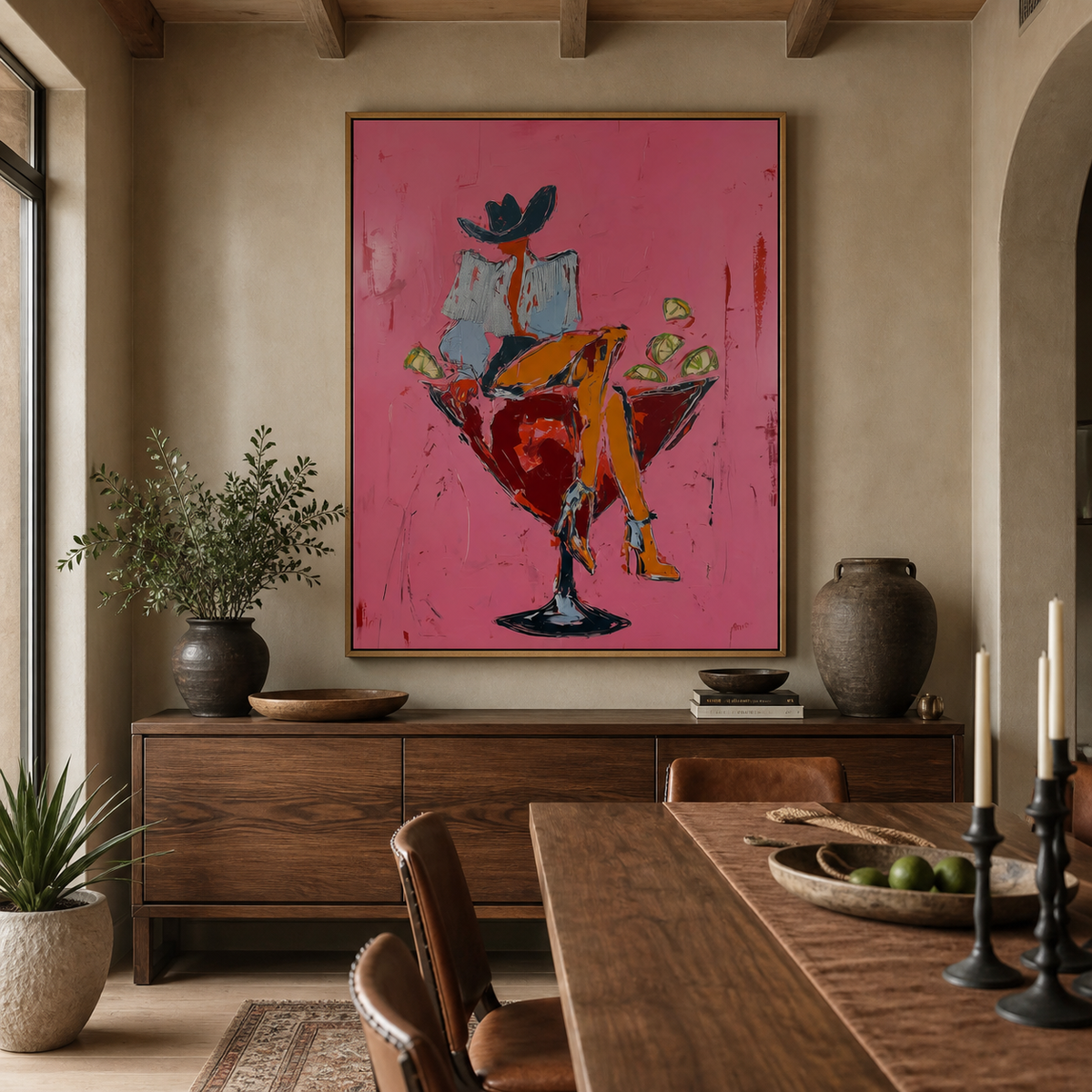 Cocktail cowgirl wall art with a hat-wearing woman seated in a red martini glass displayed above an entryway console.