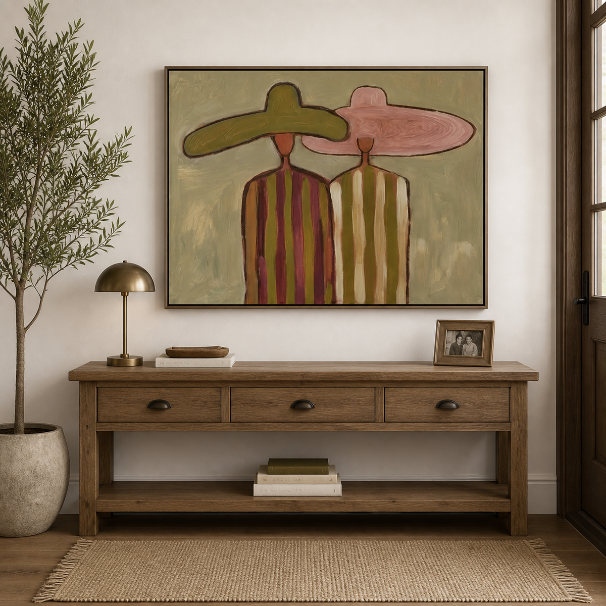 Horizontal Western wall art of two cowboys in olive and pink hats displayed above a neutral living room sofa.
