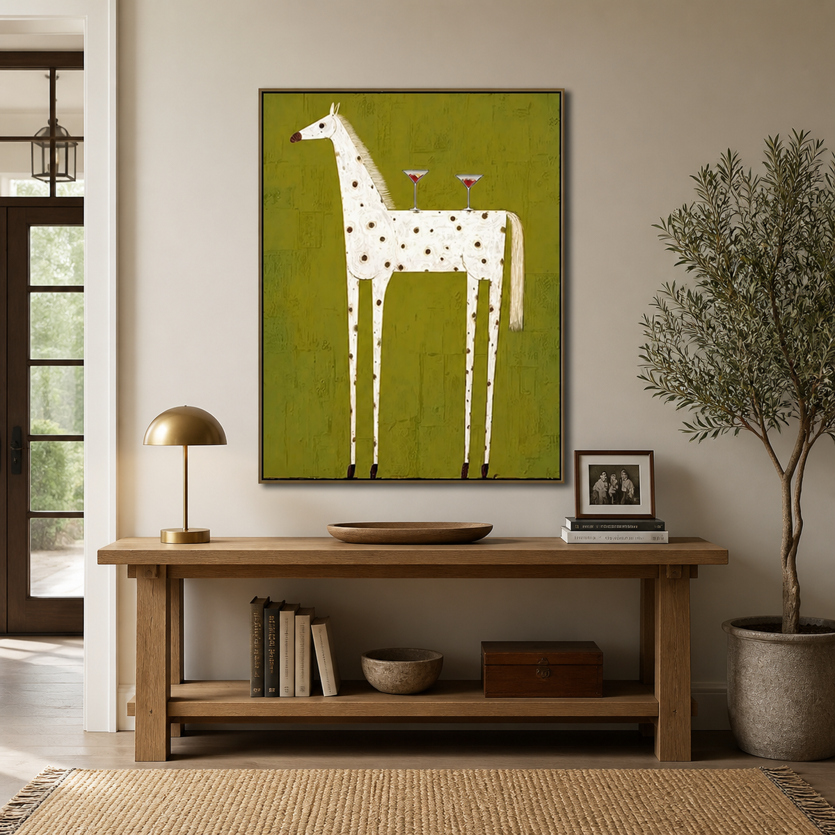 Whimsical white spotted horse wall art with two cocktail glasses on an olive-green background displayed above a sofa.