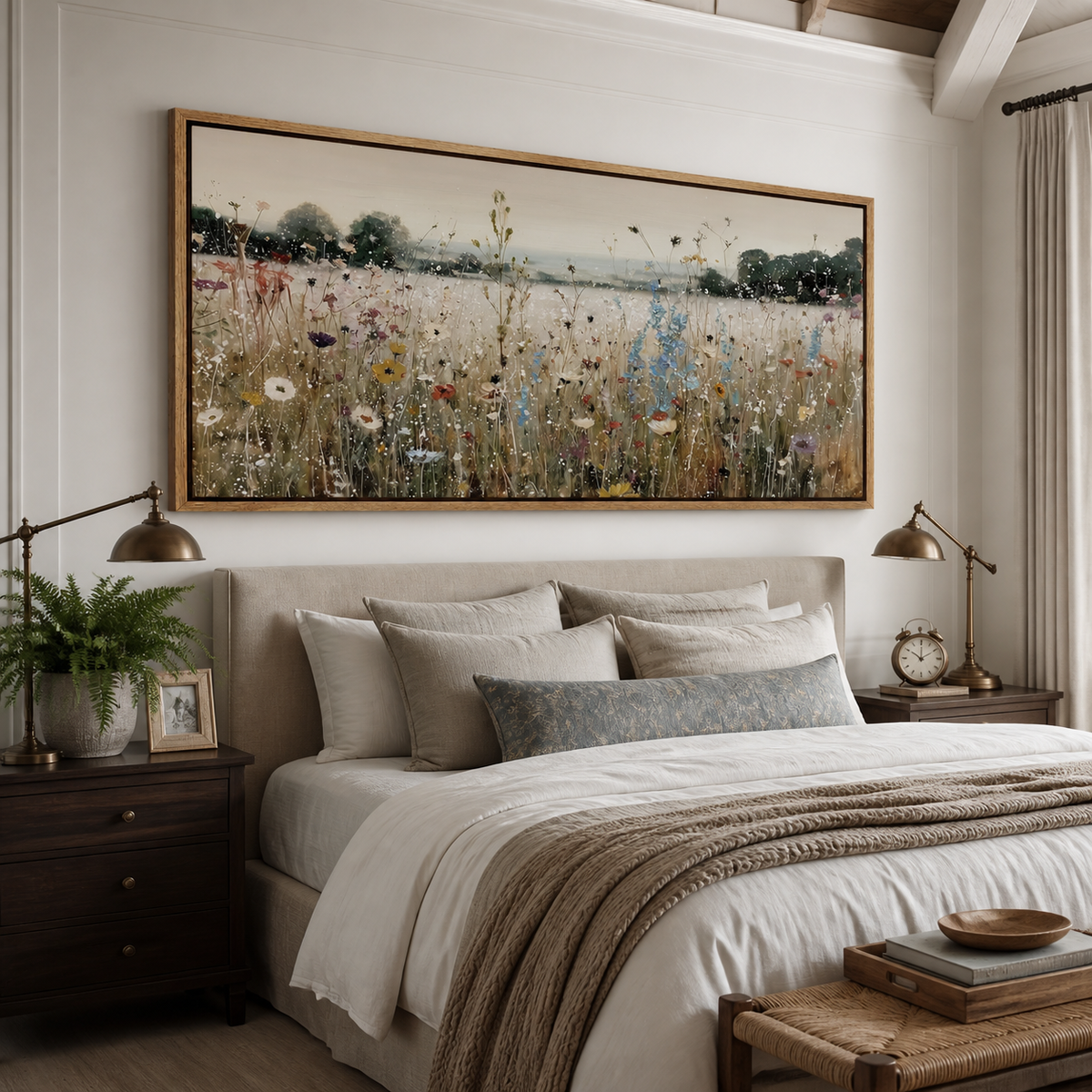 Panoramic wildflower meadow wall art with white, blue and coral flowers displayed above a neutral living room sofa.
