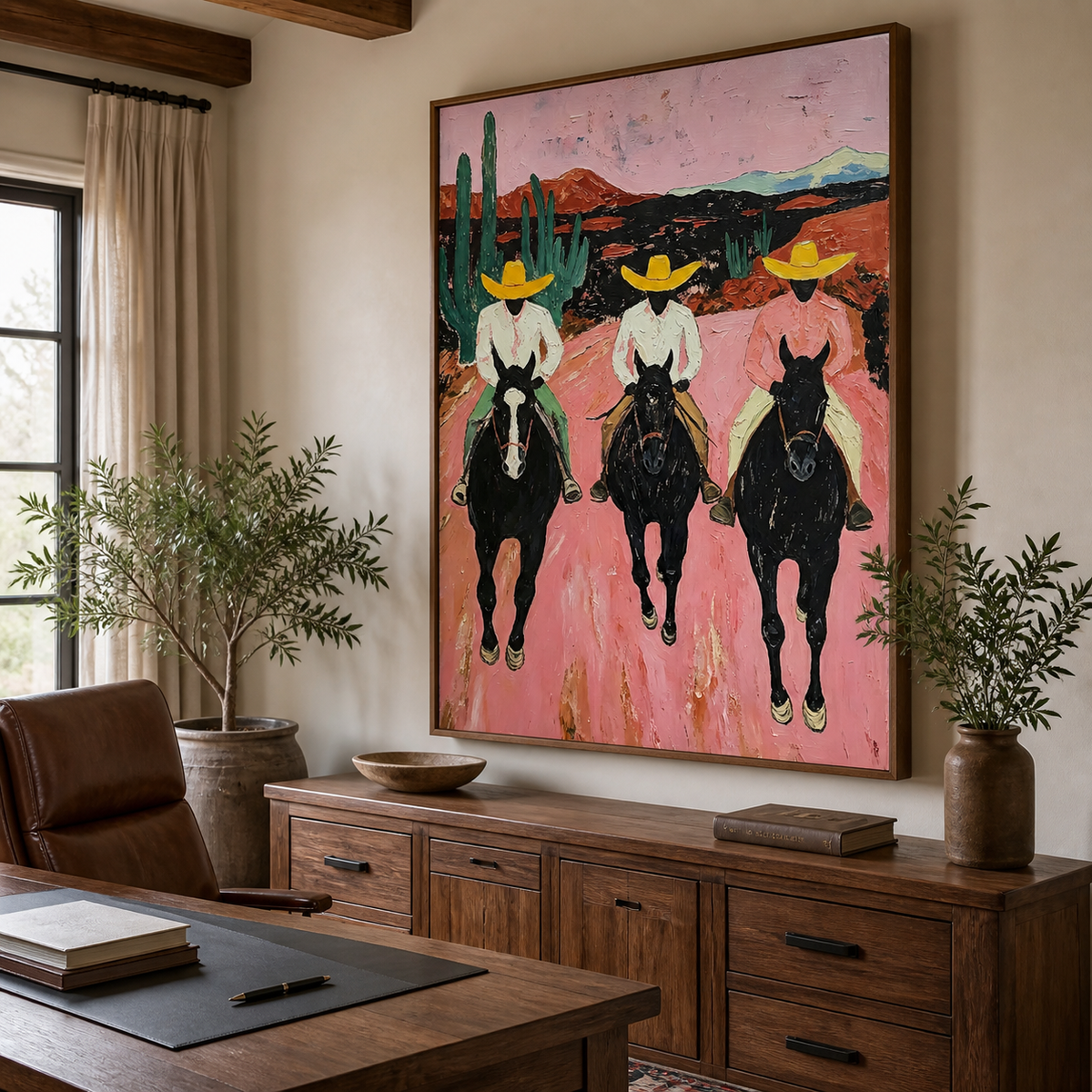 Three cowboys in yellow hats riding black horses through a pink desert on vertical wall art