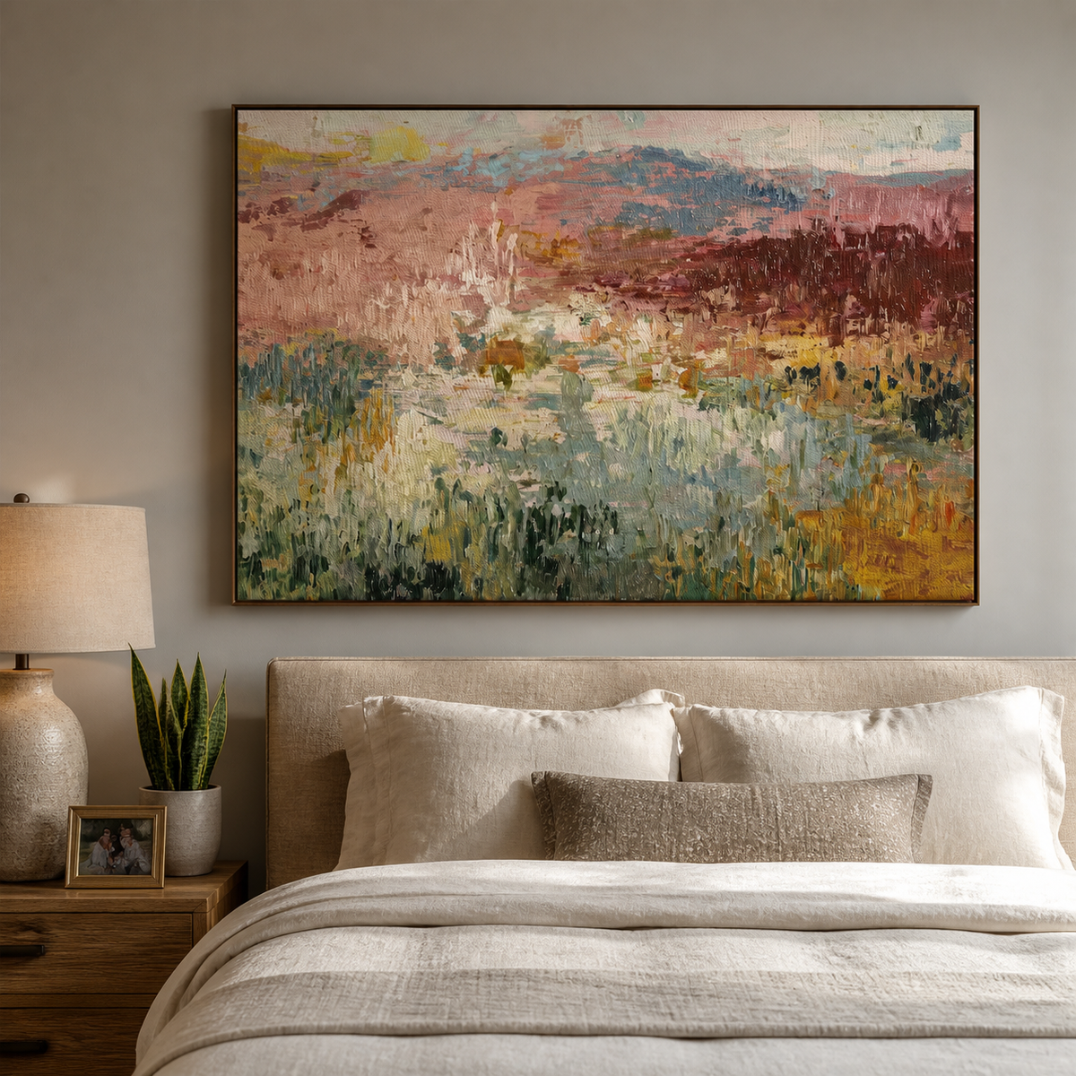 Abstract meadow wall art with textured sage green, dusty pink and ochre fields displayed above a neutral bedroom bed.