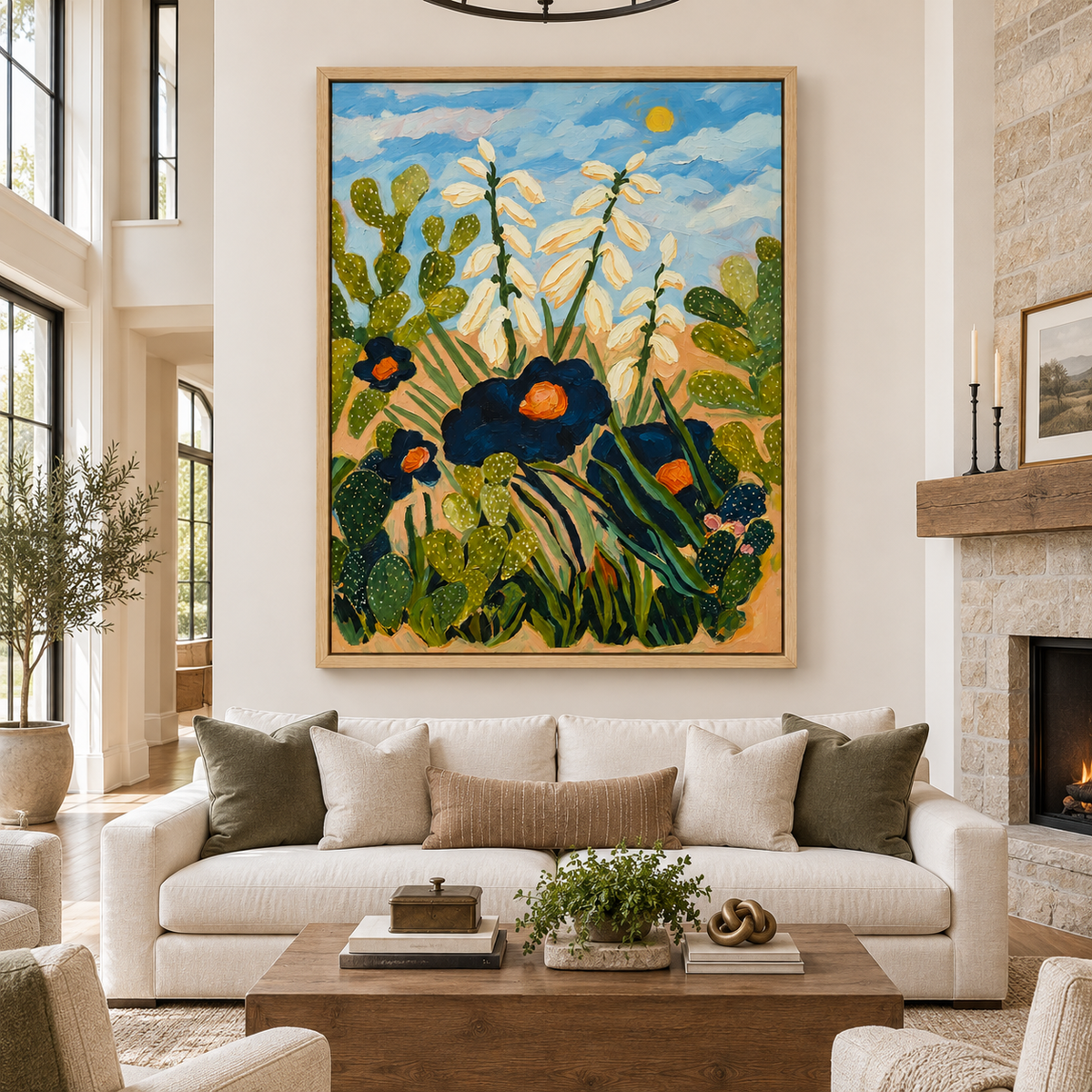 Large vertical cactus wall art with prickly pear plants, white yucca flowers and dark blue blossoms above a cream sofa