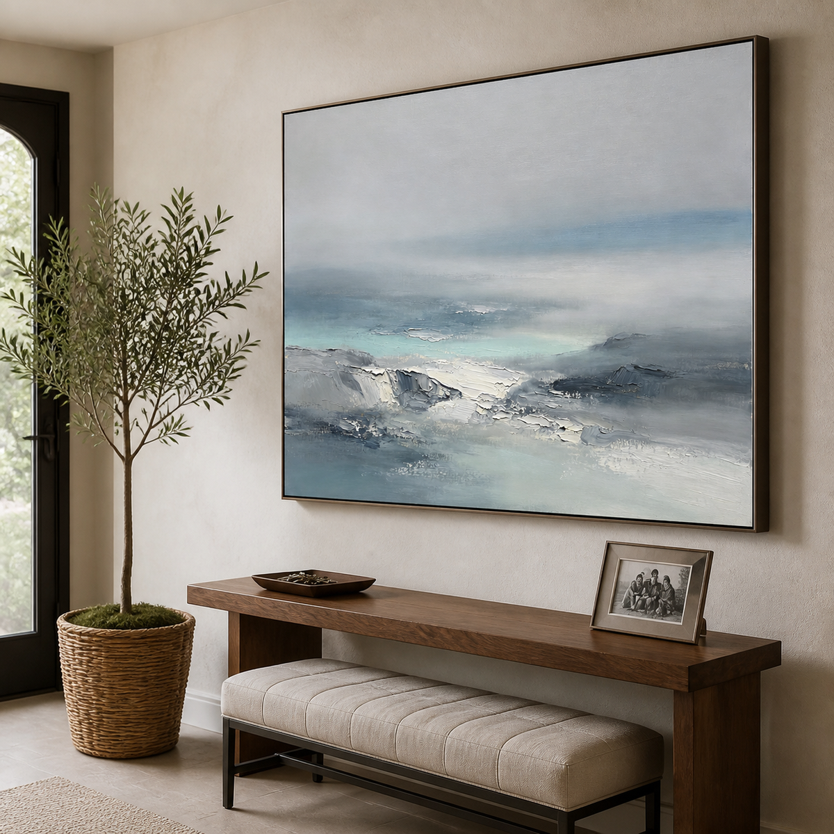 Blue-gray abstract seascape wall art featuring textured ocean waves fading into a soft misty horizon.