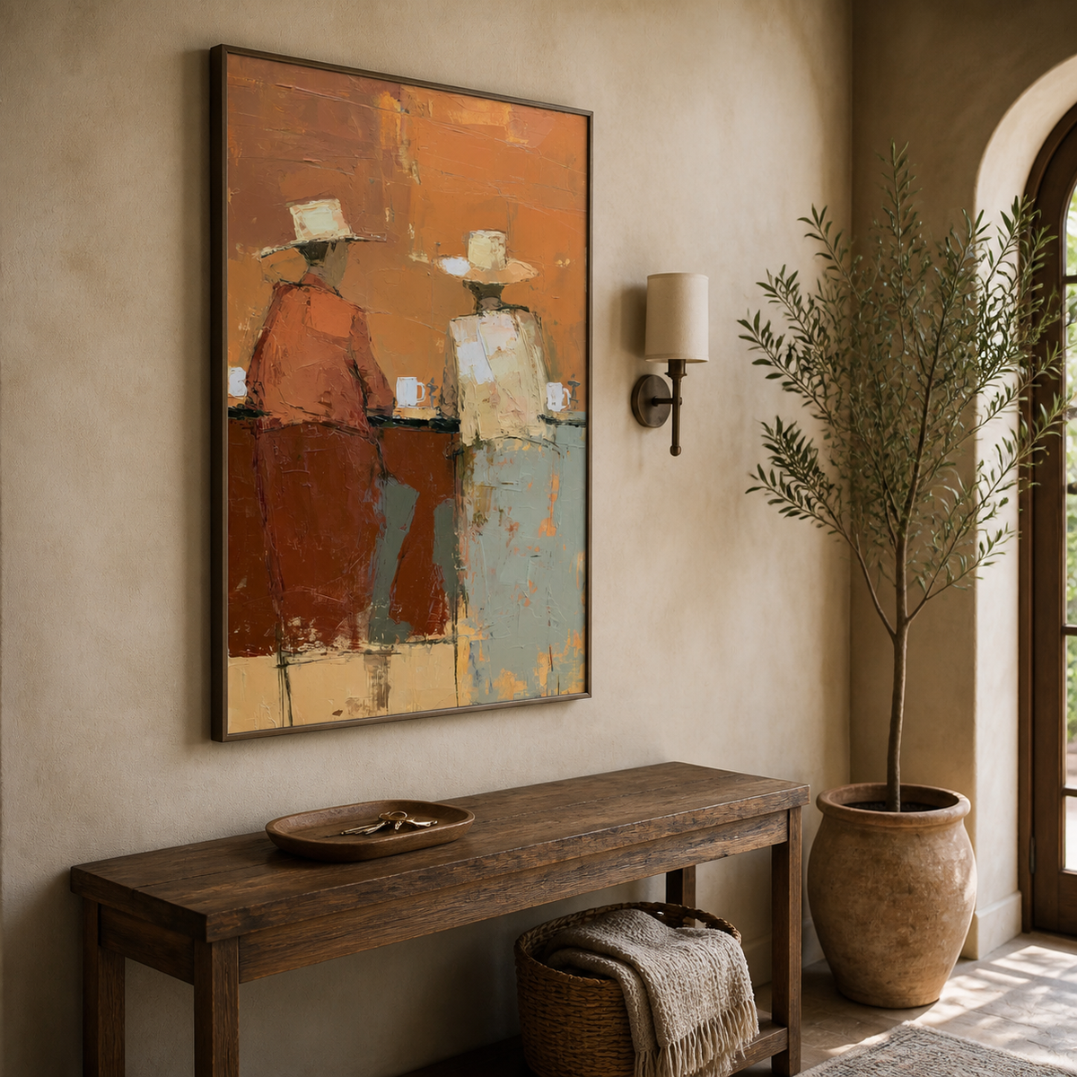 Vertical Western wall art showing two cowboys seated at a bar in orange, cream and pale blue, displayed above a wooden dining table.