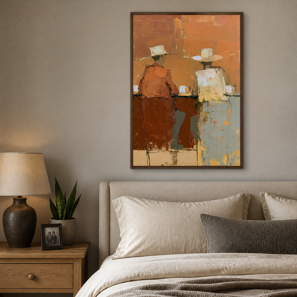 Vertical Western wall art showing two cowboys seated at a bar in orange, cream and pale blue, displayed above a wooden dining table.