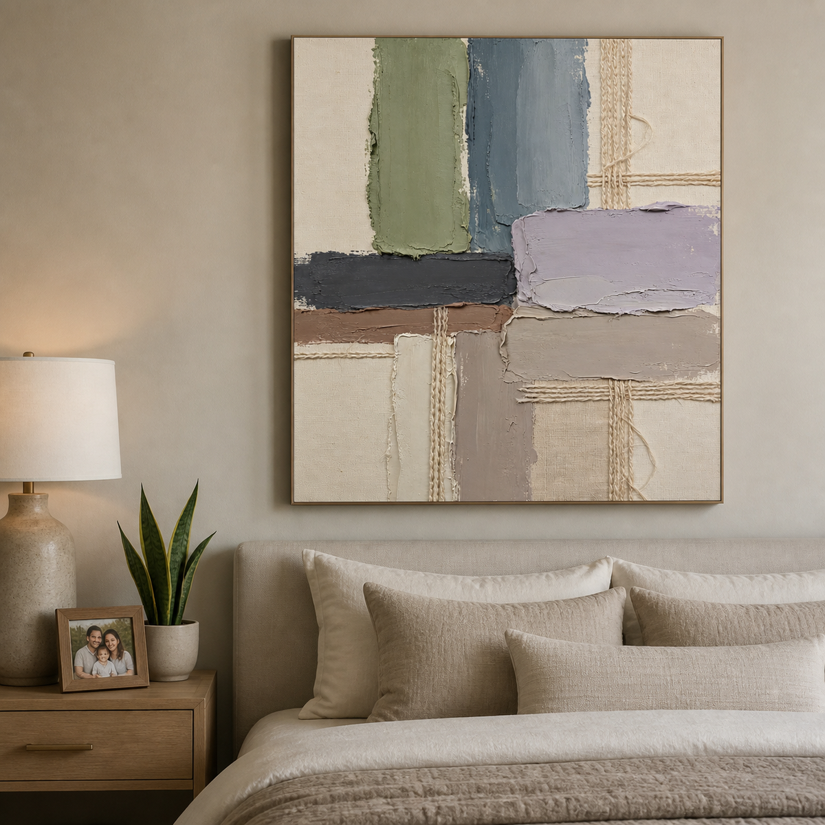 Vertical neutral textured wall art with sage, slate gray, lavender and ivory geometric blocks and woven details displayed above a sofa.
