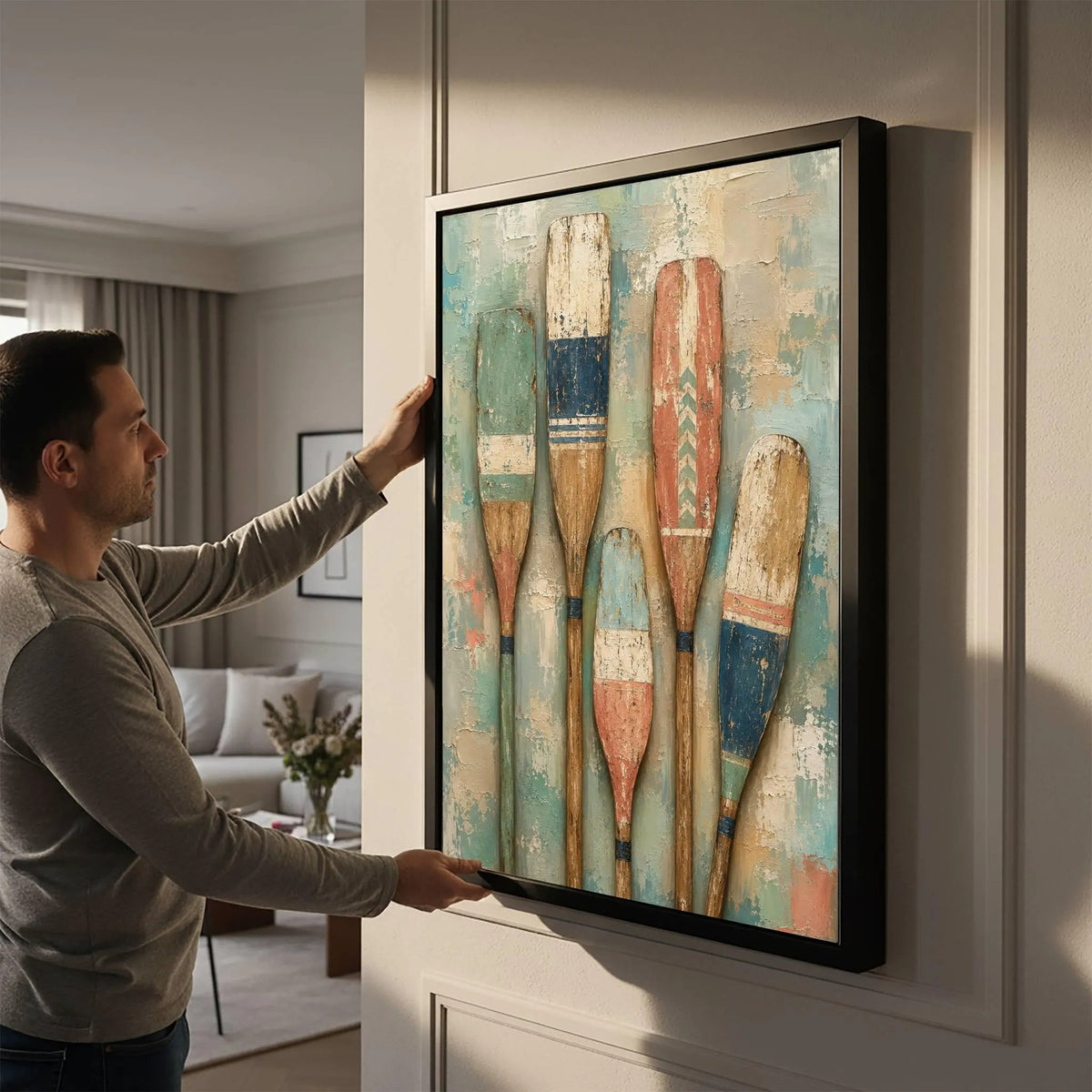 Five upright wooden paddles painted in faded teal, blue, cream and rust against a mottled pale teal background, shown in room setting 5.