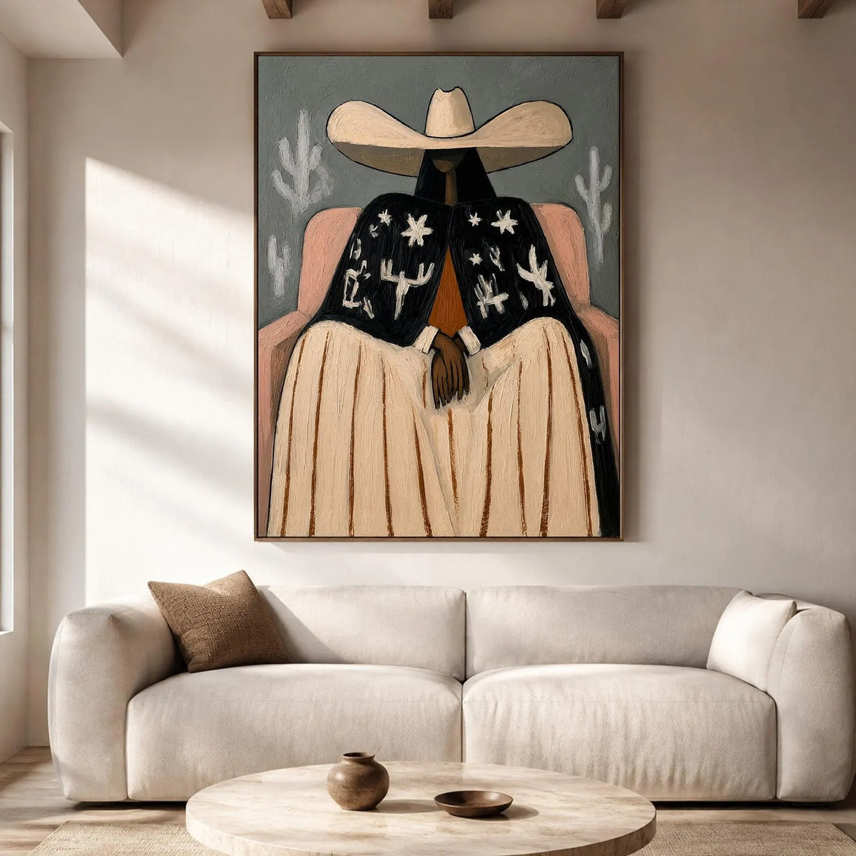 A seated cowgirl in a broad cream hat, pale skirt and black jacket patterned with white desert motifs against a gray background, shown in room setting 2.
