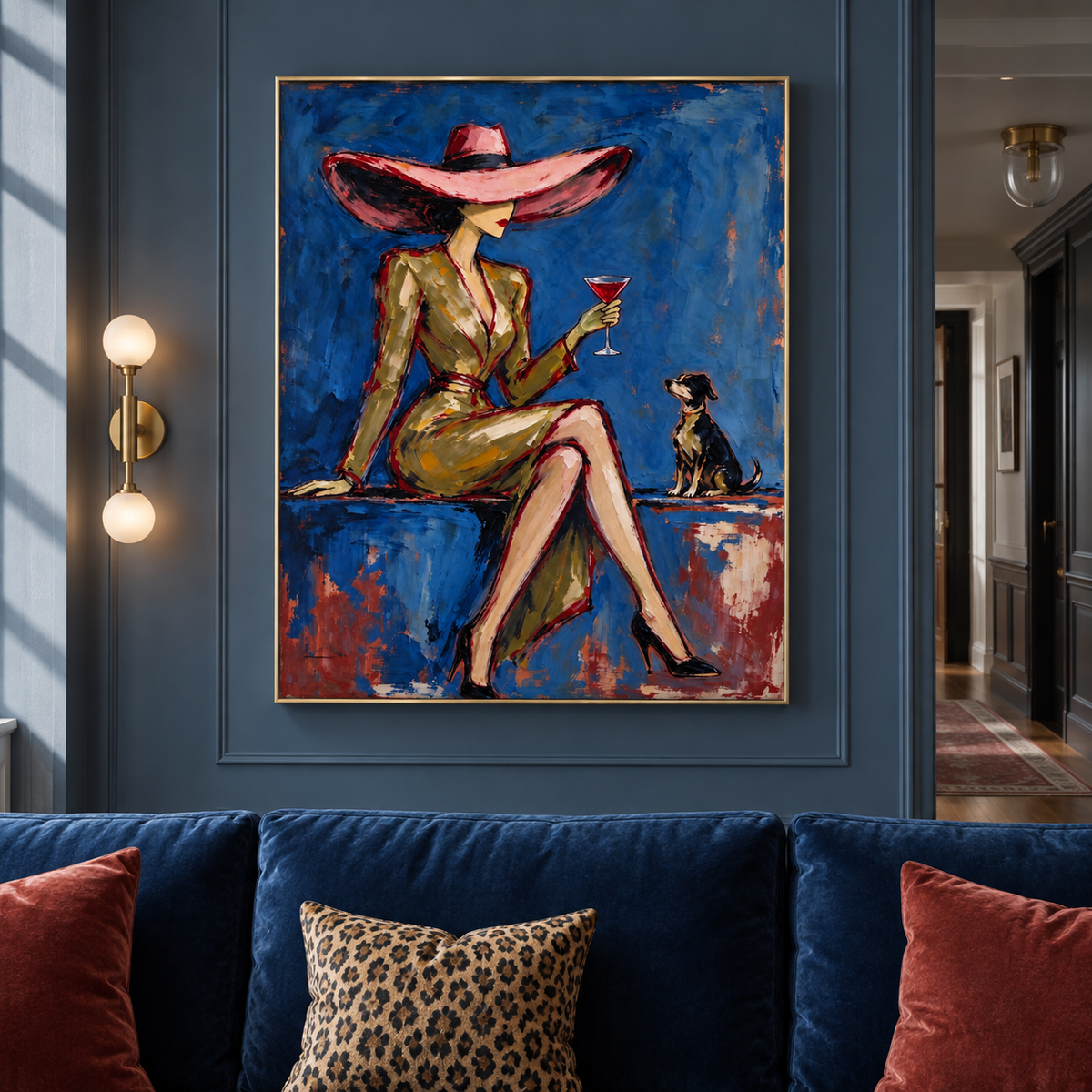 A seated woman in an oversized pink hat holding a red cocktail beside a small dark dog against a rich blue background, shown in a eclectic living room.