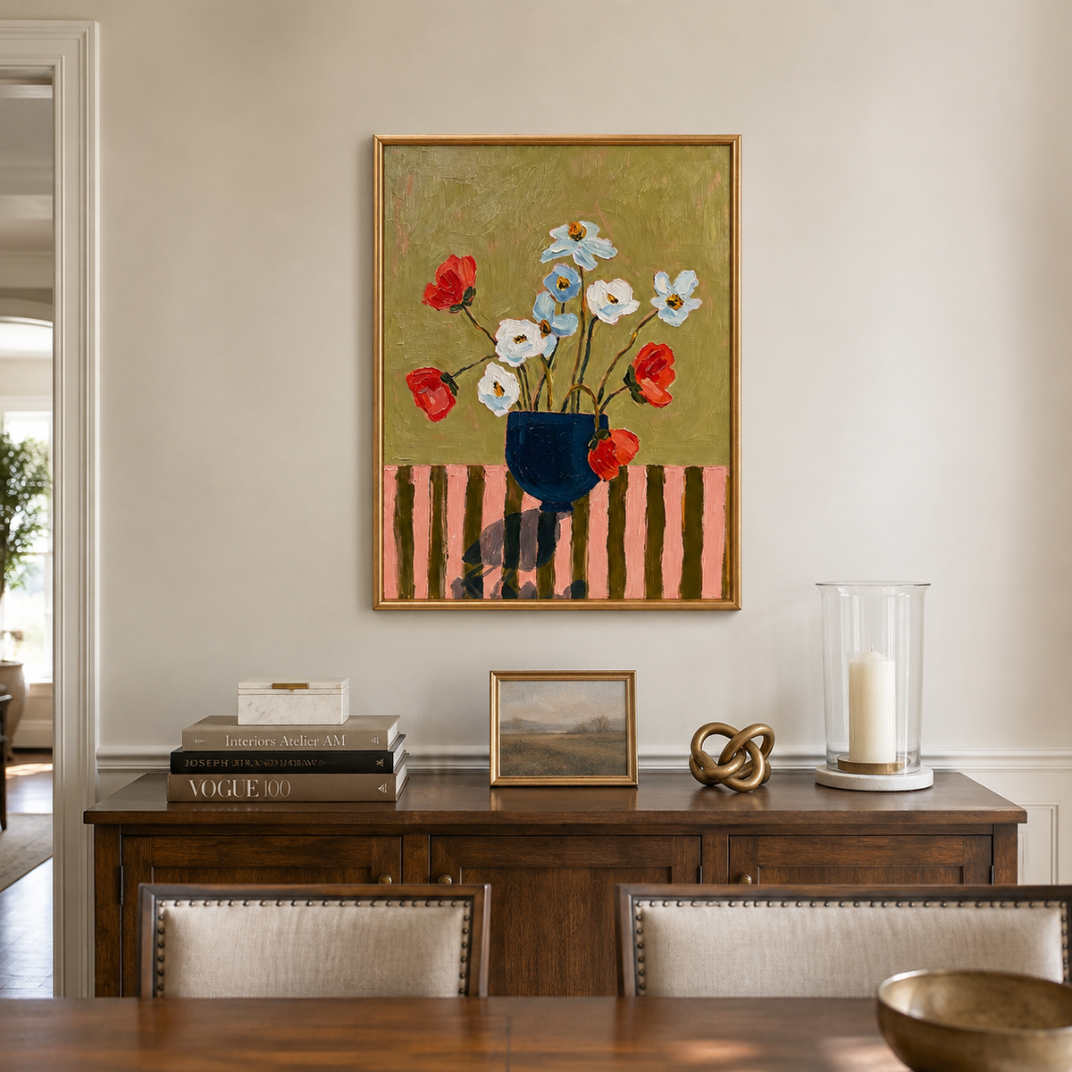 Red, white, and pale blue flowers in a navy vase against an olive background, in a dining room.
