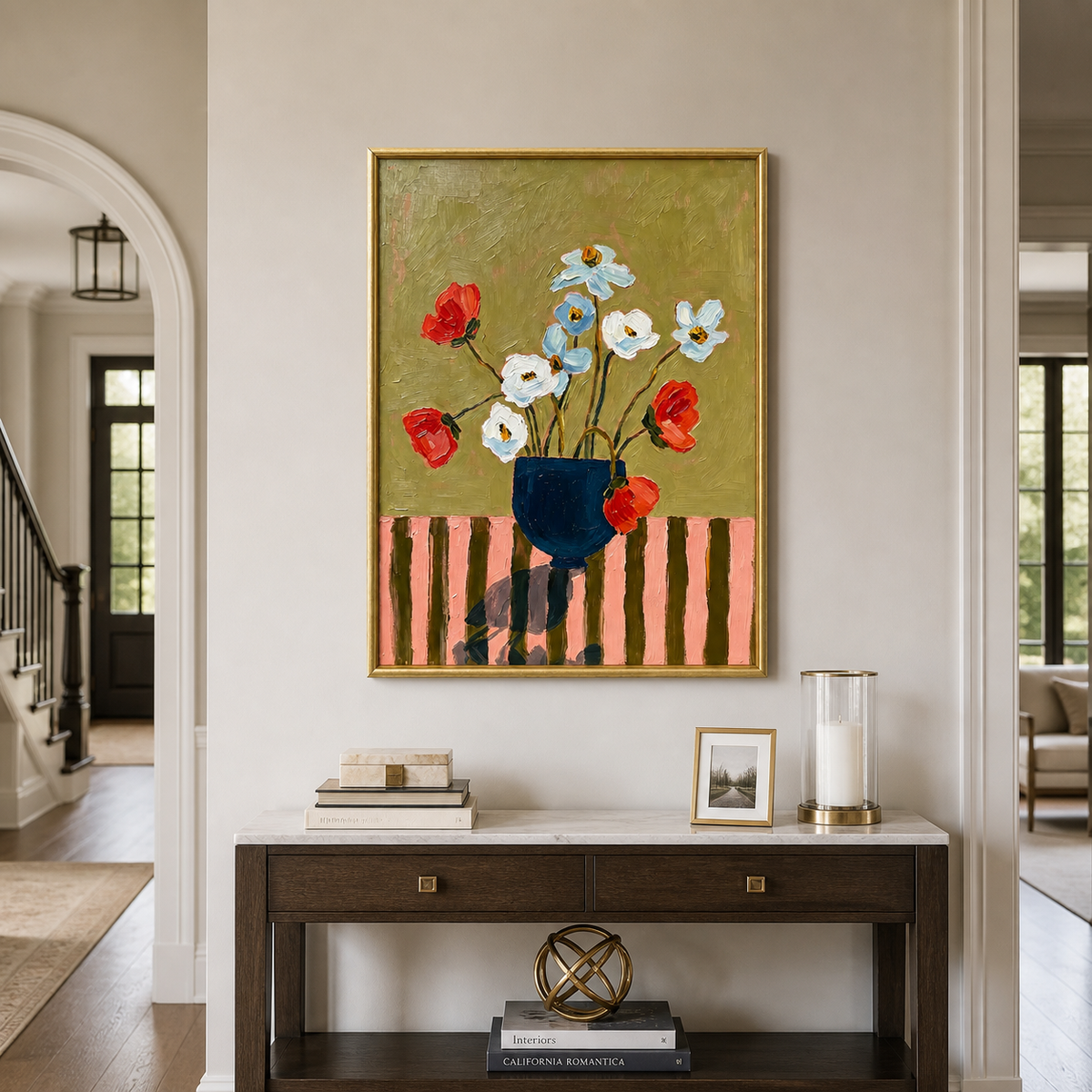 Red, white, and pale blue flowers in a navy vase against an olive background, in an entryway.