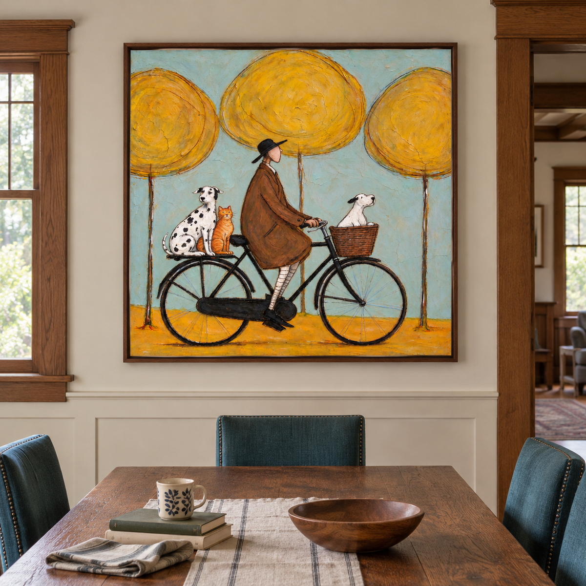 A man in a brown coat riding a black bicycle with a white dog in the front basket and a Dalmatian and orange cat on the rear rack beneath three round yellow trees against pale blue, shown in room setting 2.