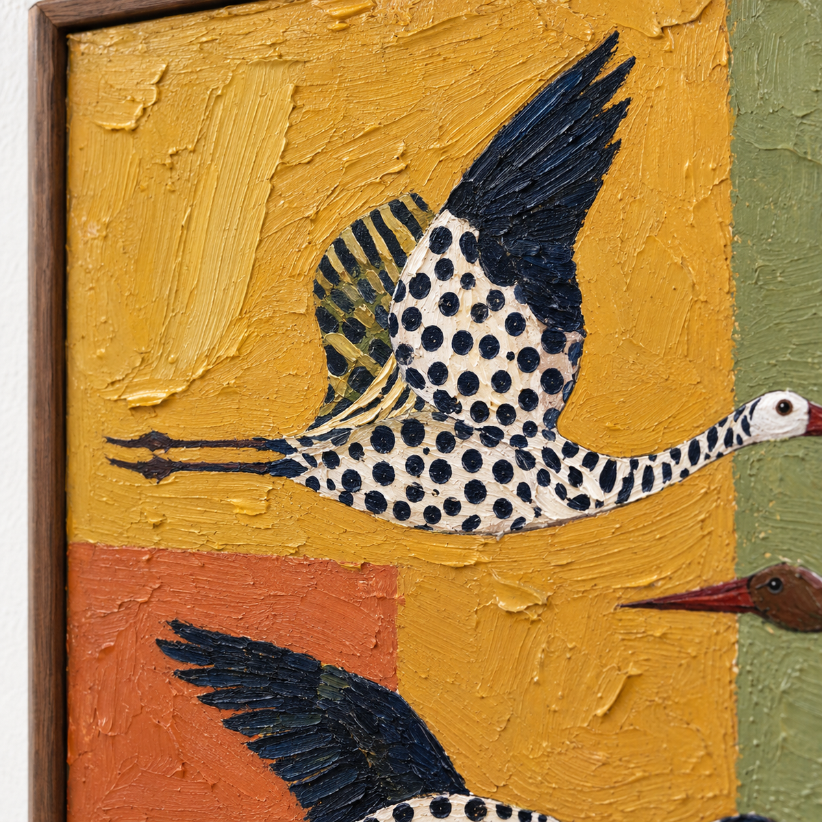 Spotted and striped flying birds over ochre, burnt orange, olive green, cream, and dusty rose blocks, close-up of a spotted bird.