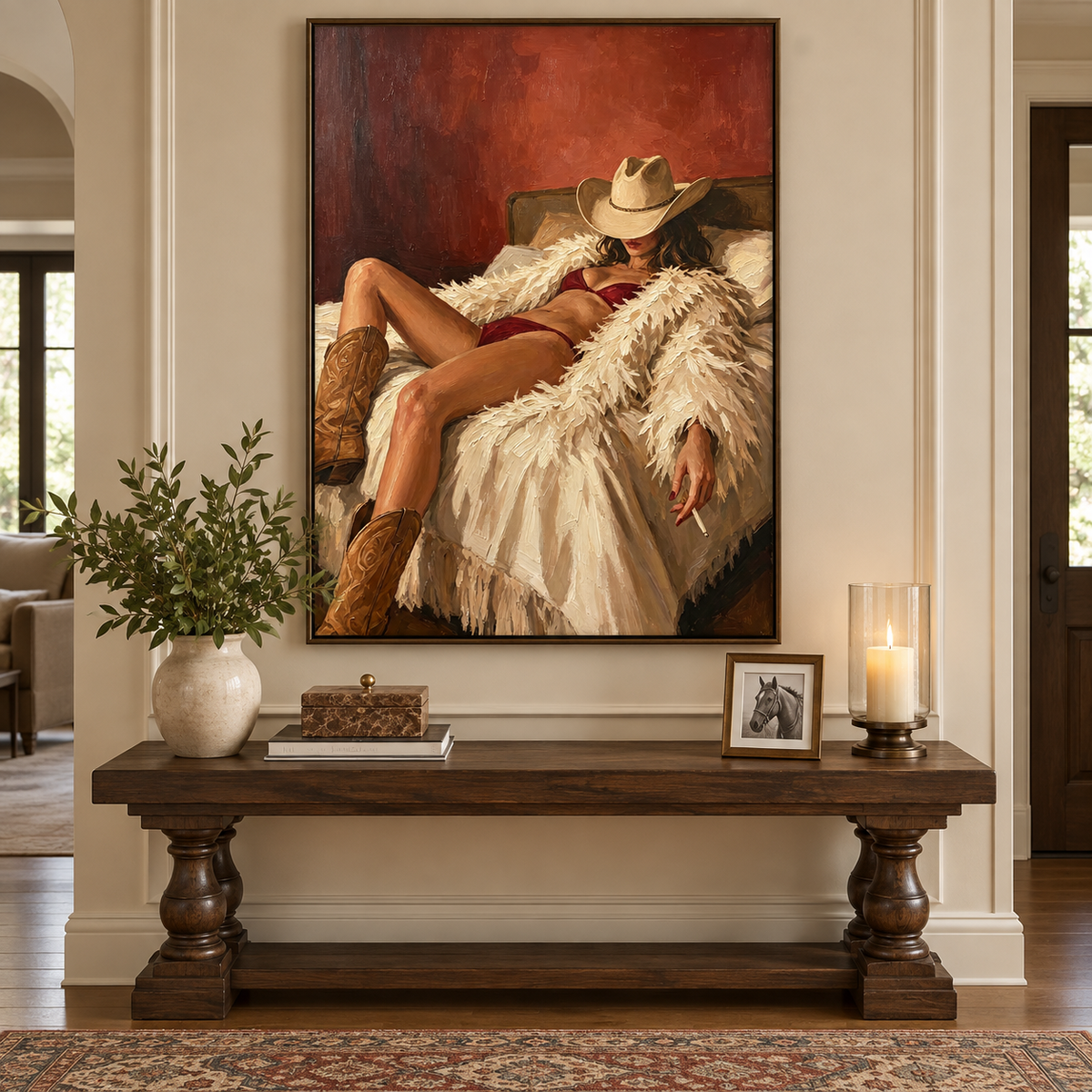 A reclining cowgirl in a tan hat, burgundy lingerie, and brown boots against cream bedding and a red wall, in an entryway.