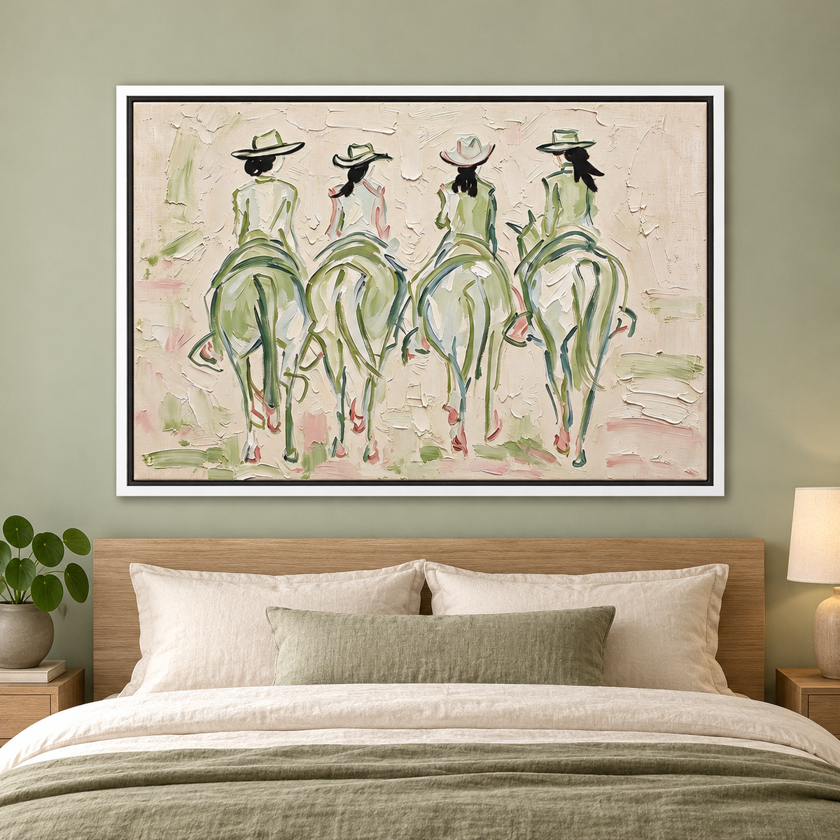 Four cowgirls on horseback seen from behind, with wide-brimmed hats and long dark ponytails, outlined in sage green and pale pink against a cream background, shown in room setting 3.
