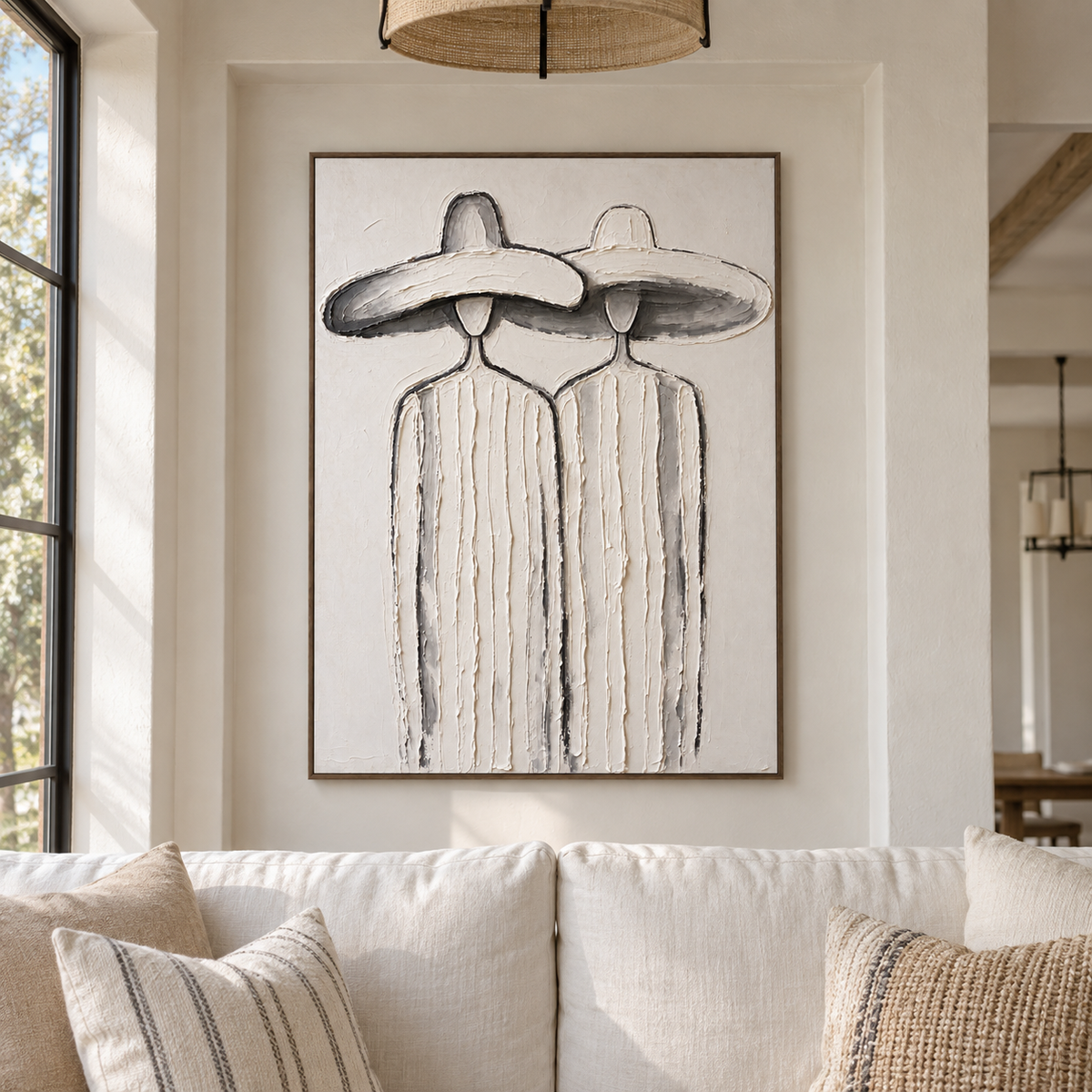 Two slender faceless figures in pale striped clothing and overlapping broad white hats, shown in a california living room.