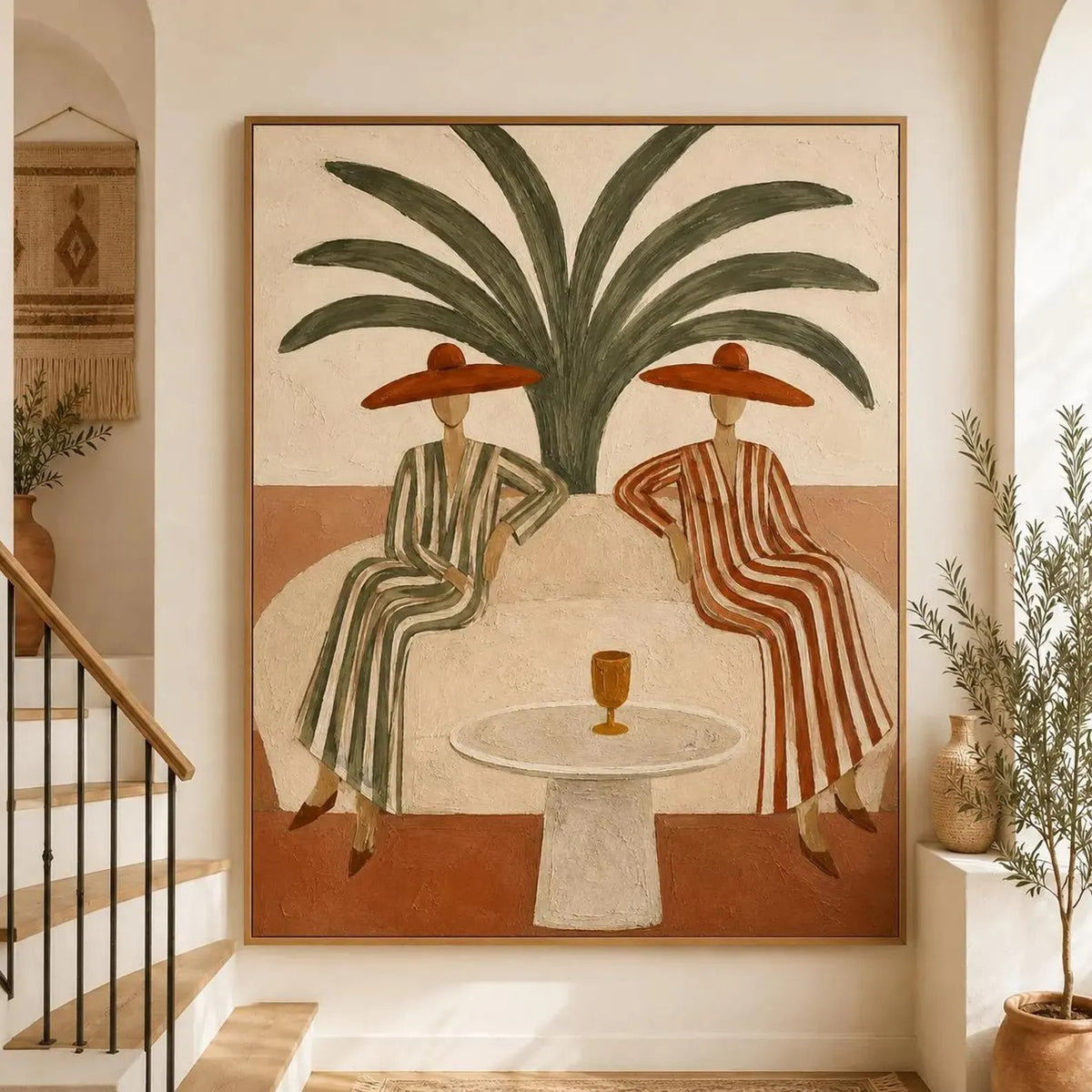 Two women in striped dresses and rust-colored hats seated at a round table beneath a large palm, shown in room setting 1.