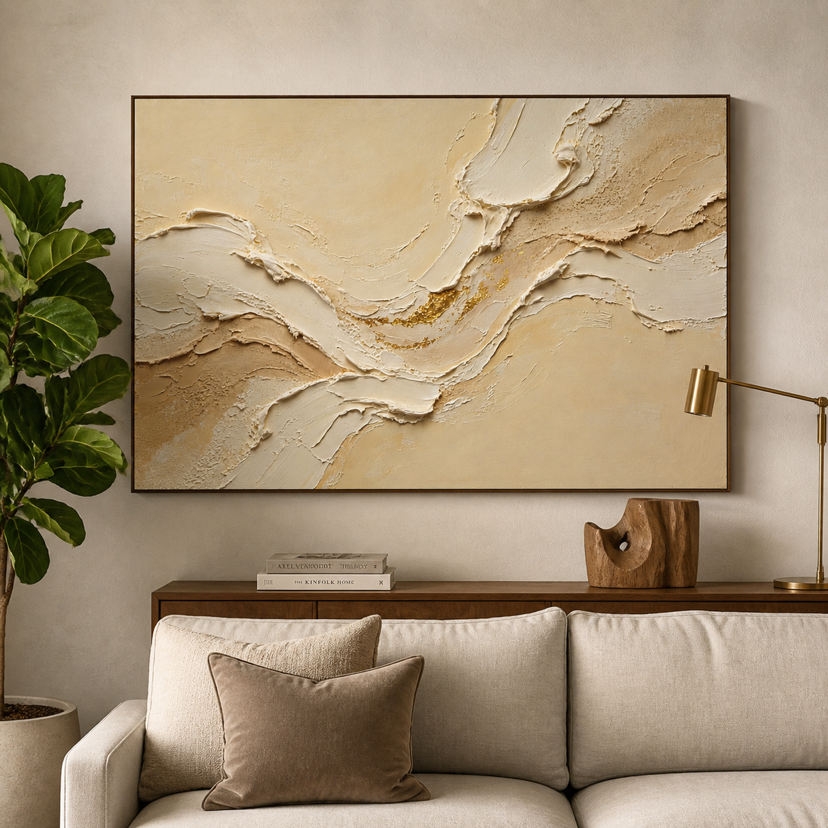 Wide neutral textured wall art with layered ivory and beige wave forms and gold accents displayed above a living room sofa.