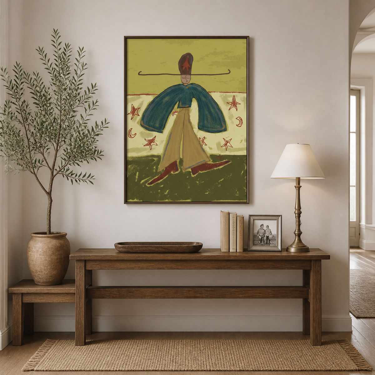 Colorful Western woman wall art with a teal cape, golden skirt and star motifs displayed above a neutral living room sofa.