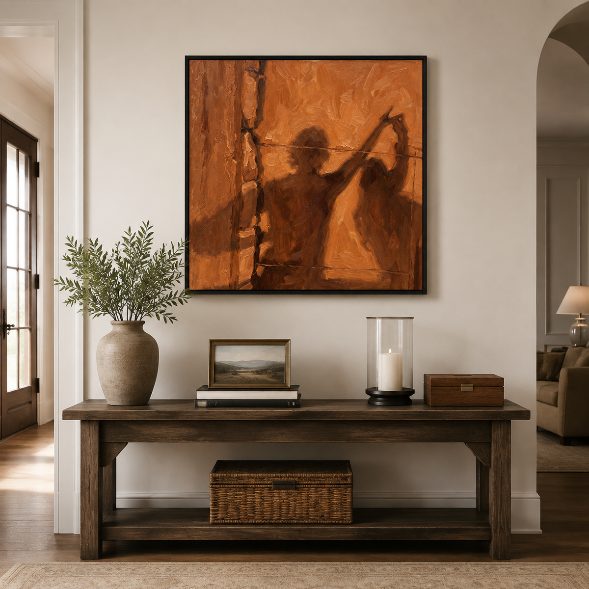 Square brown abstract figurative wall art depicting a fashion fitting or dressmaker studio scene above a dark wood entryway table