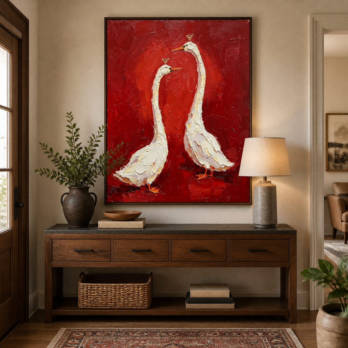 White goose wall art with two birds on a textured red background displayed above a neutral sofa.