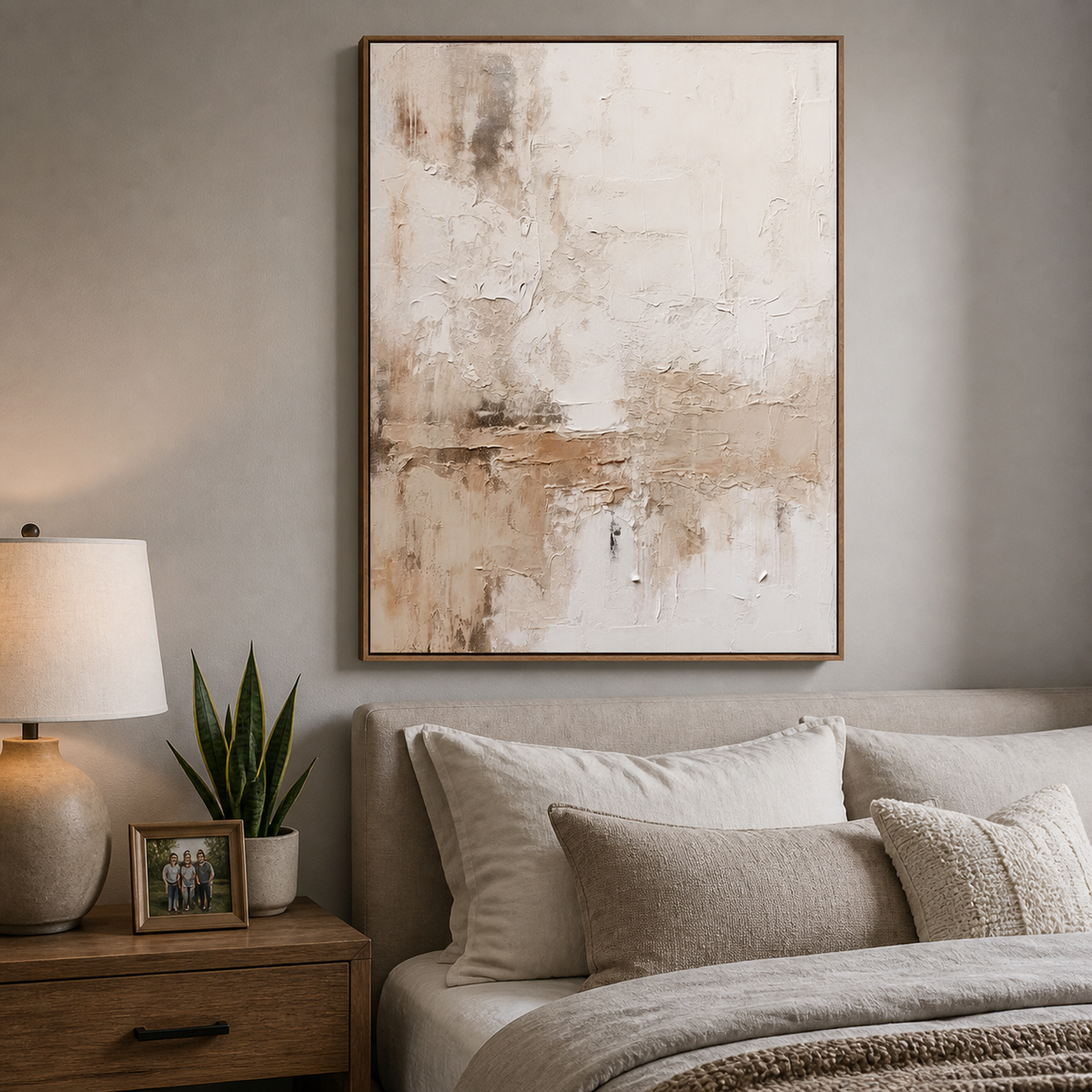 Vertical neutral textured wall art with layered ivory, beige and taupe abstract details displayed above a wooden dining table.