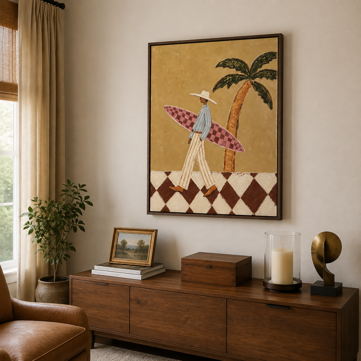Large vertical surfer wall art showing a person carrying a pink checkerboard surfboard beneath a palm tree above a cream sectional sofa