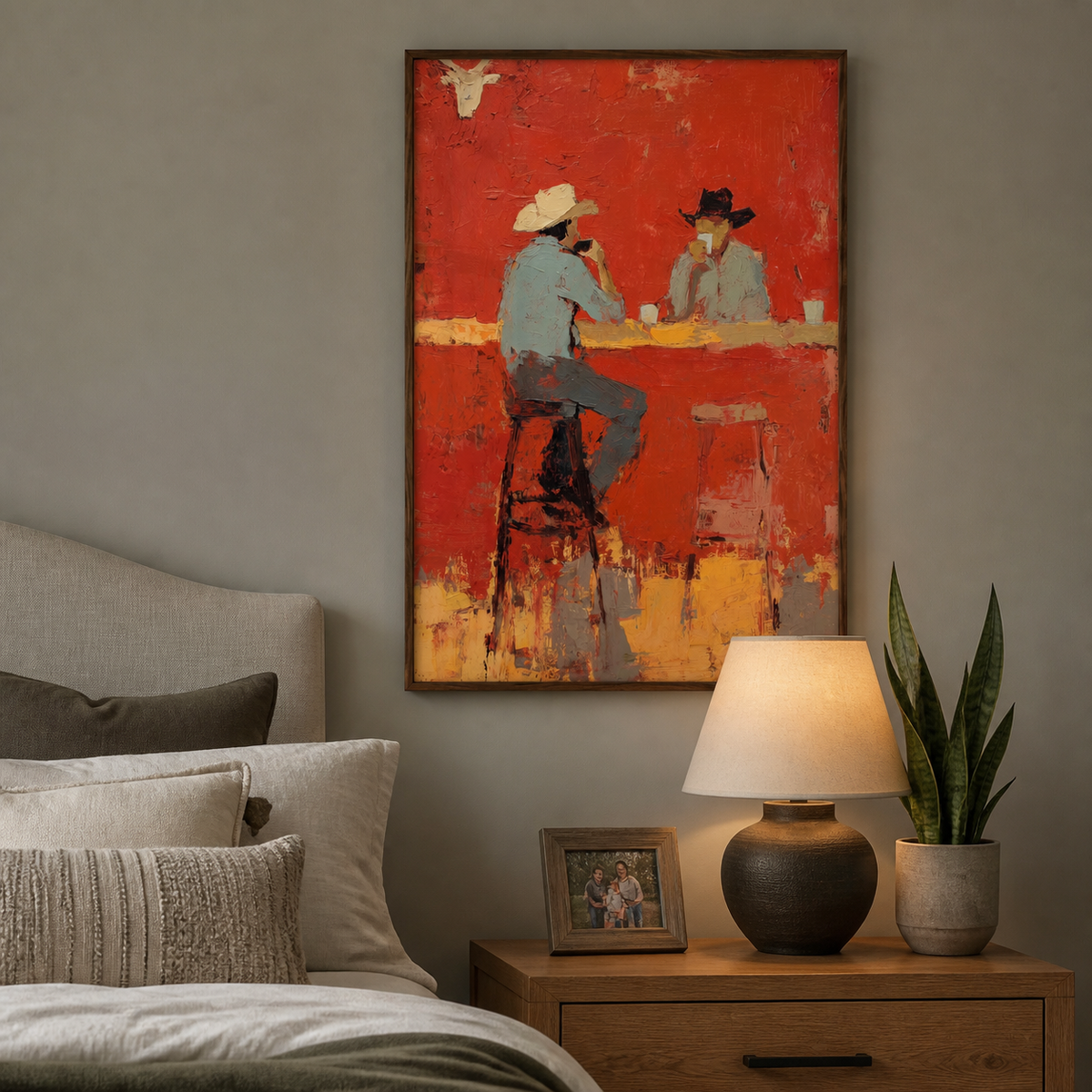 Vertical Western cowboy wall art showing two hat-wearing figures at a red-orange bar, displayed above a neutral living room sofa.