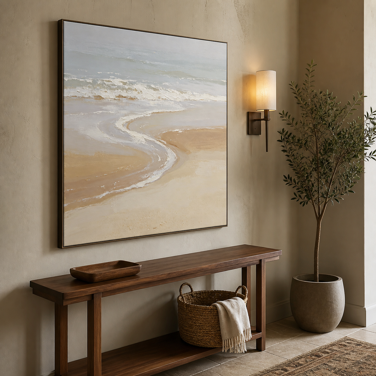 Square neutral coastal wall art with soft blue-gray ocean waves and a curved beige shoreline displayed above a wooden dining table.