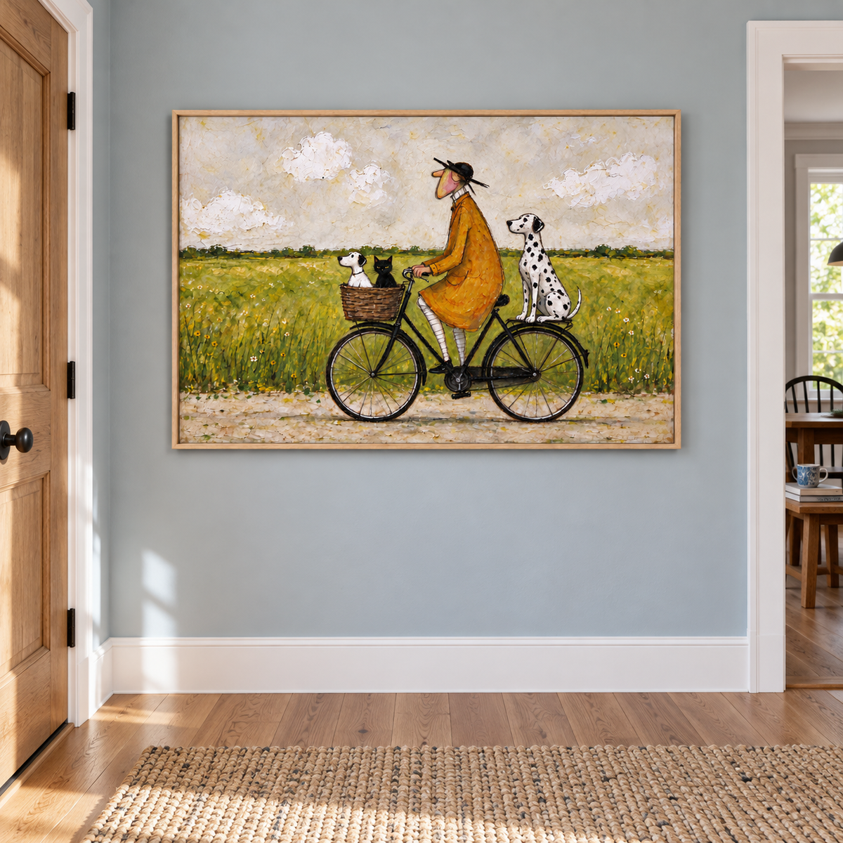 A man in an ochre coat riding a black bicycle with a small white dog and black cat in the front basket and a Dalmatian sitting over the rear wheel beside a green meadow, shown in room setting 3.