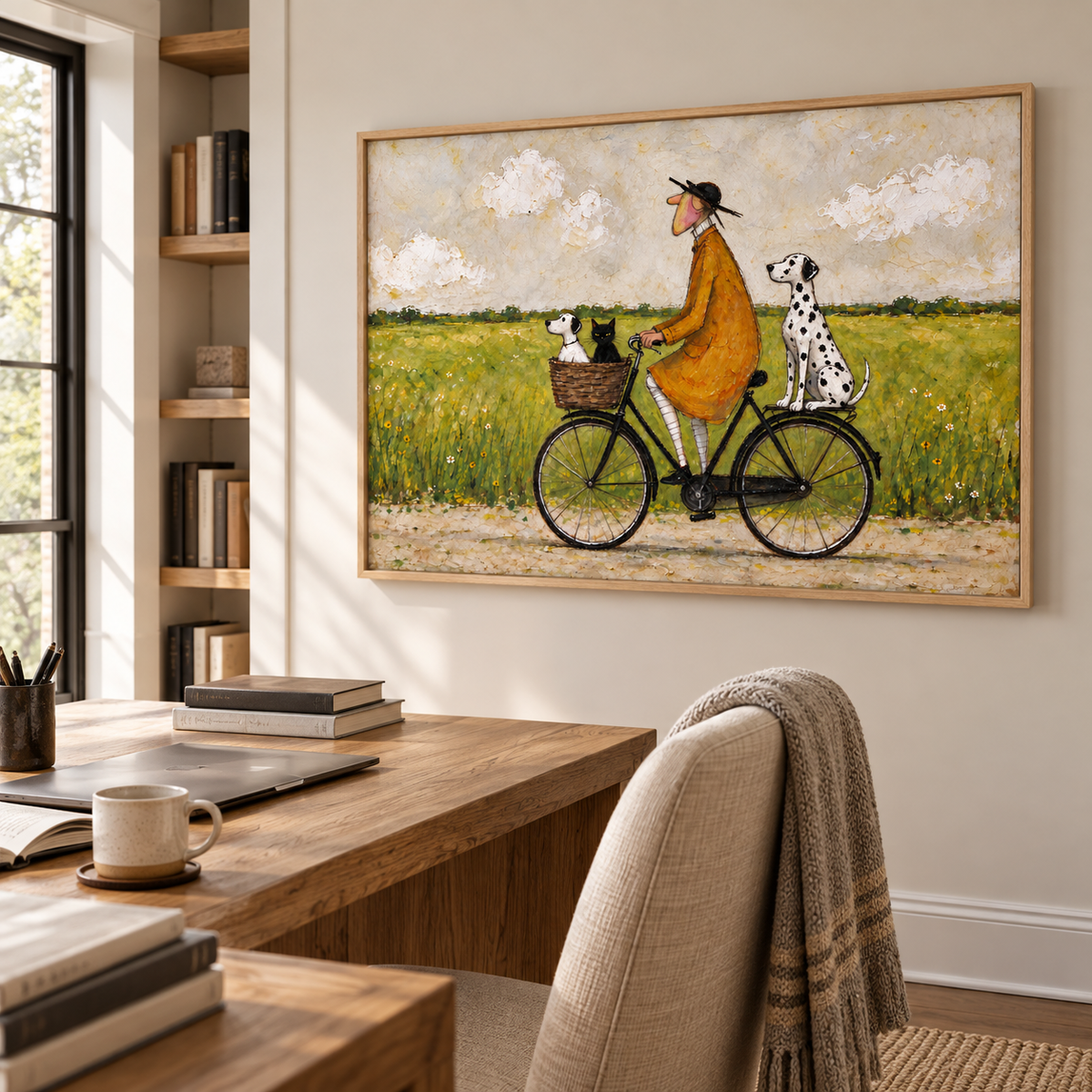 A man in an ochre coat riding a black bicycle with a small white dog and black cat in the front basket and a Dalmatian sitting over the rear wheel beside a green meadow, shown in room setting 5.