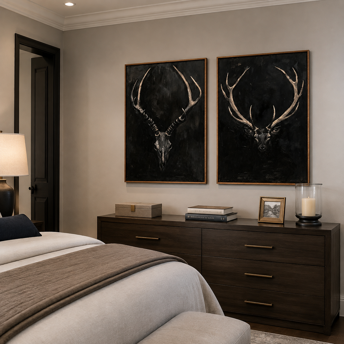 An antlered skull and a stag head against black backgrounds, shown from an angle in a bedroom.