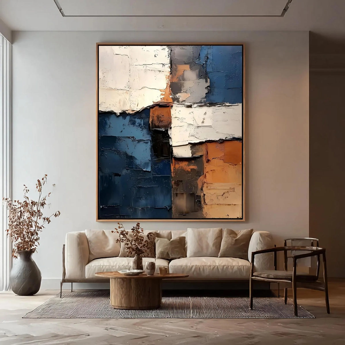 Rough-edged blocks of deep blue, ivory and rust orange in a vertical abstract composition, shown in room setting 2.