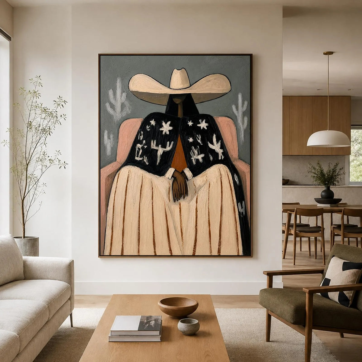 A seated cowgirl in a broad cream hat, pale skirt and black jacket patterned with white desert motifs against a gray background, shown in room setting 4.