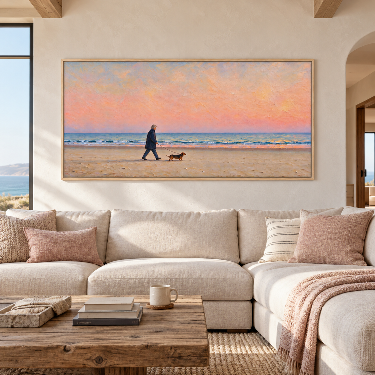 A silver-haired man in a navy coat walking a small brown dog along a sandy beach beneath a broad peach-pink sky with a narrow band of blue ocean waves, shown in room setting 1.