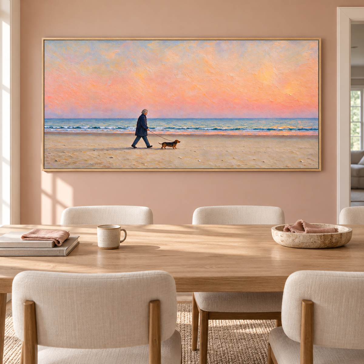 A silver-haired man in a navy coat walking a small brown dog along a sandy beach beneath a broad peach-pink sky with a narrow band of blue ocean waves, shown in room setting 2.