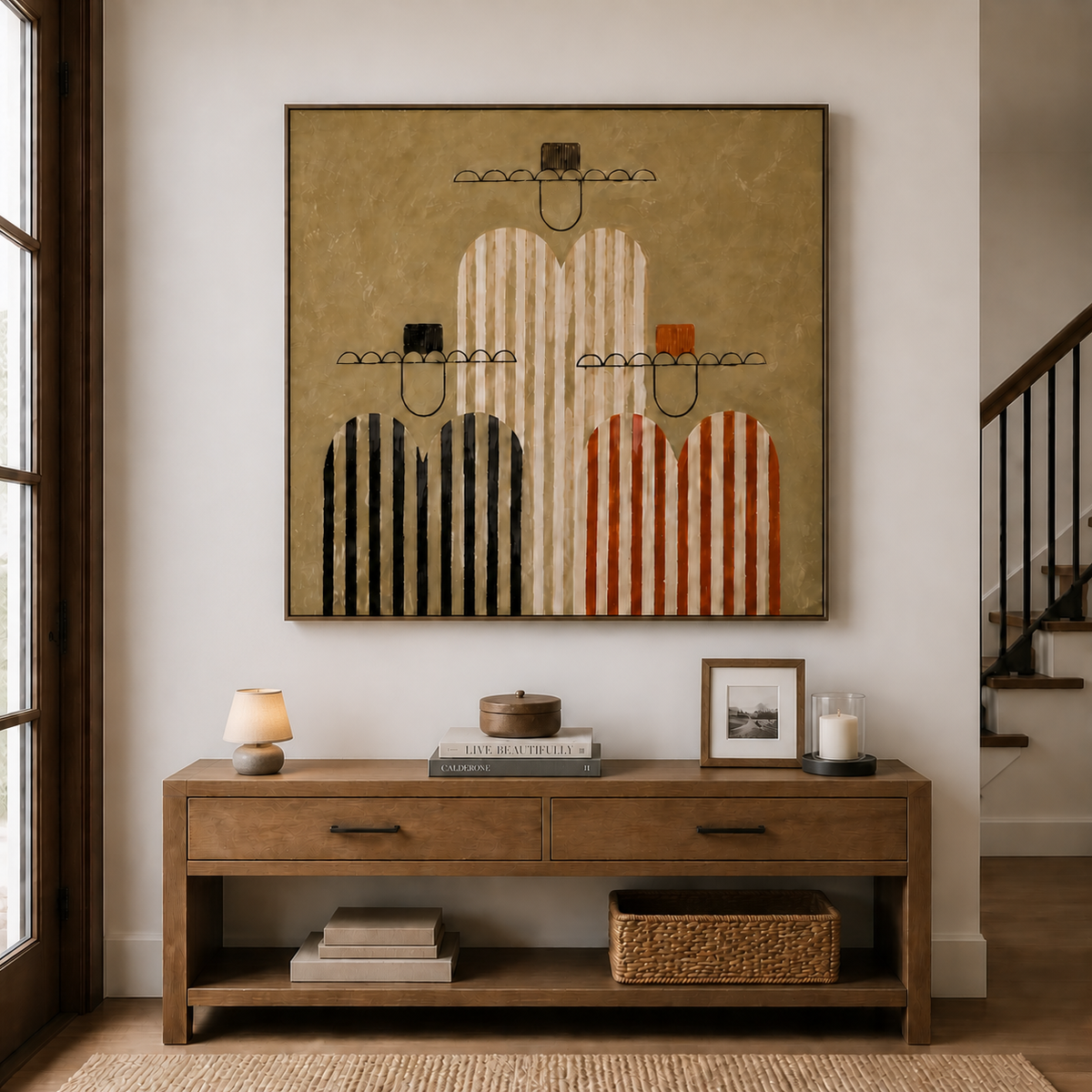 Three-cowboy wall art with striped black, cream and rust figures displayed above a wooden entryway console.