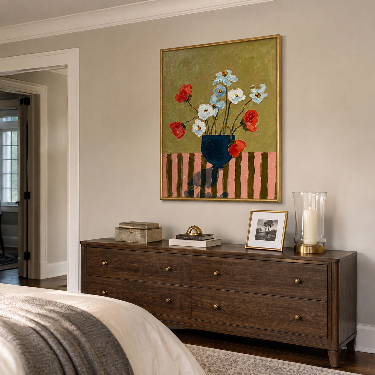 Red, white, and pale blue flowers in a navy vase against an olive background, shown from an angle in a bedroom.