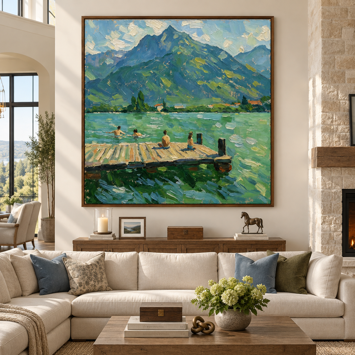 Large square mountain lake painting shown above a sofa in a high-ceiling living room.