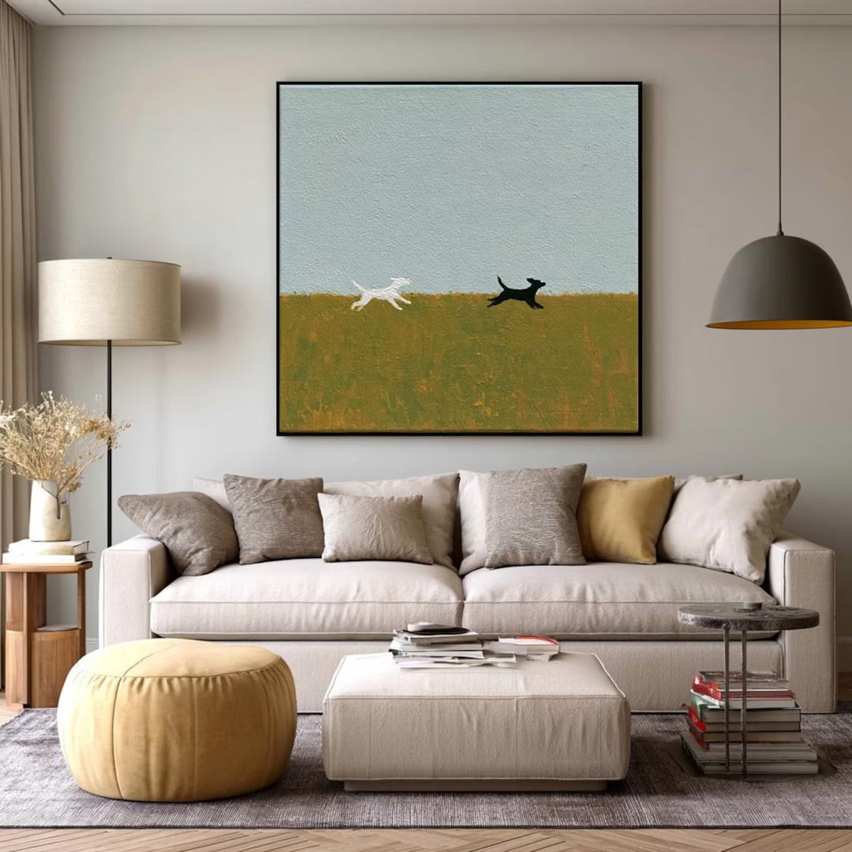 A white dog and a black dog running across an olive field beneath a large pale blue sky, shown in room setting 9.