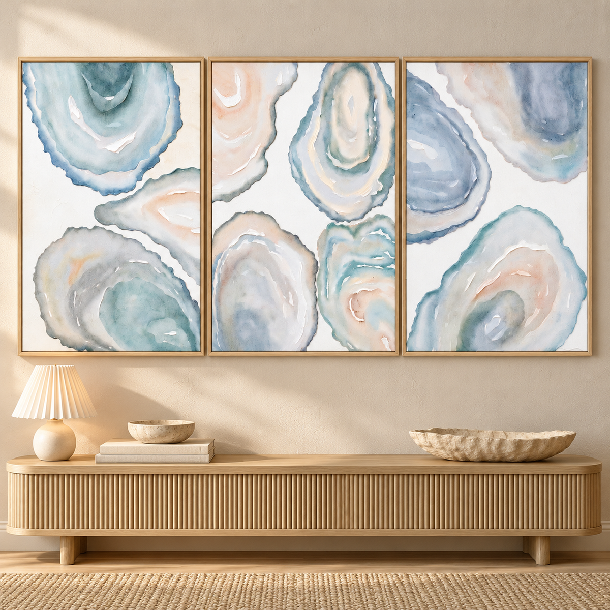 Three vertical panels of overlapping oyster-shell interiors in cloudy blue, pale aqua, warm white and soft blush, with curved ridges and layered centers, in an entryway.