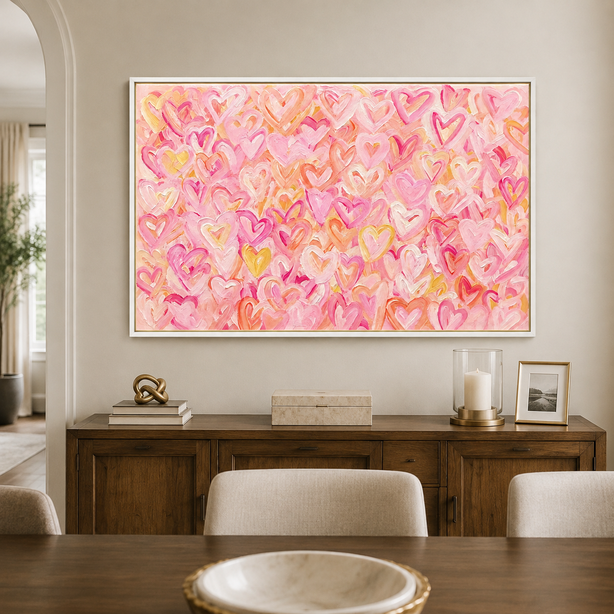 Pink, peach, and yellow hearts layered across a warm pink background, in a dining room.