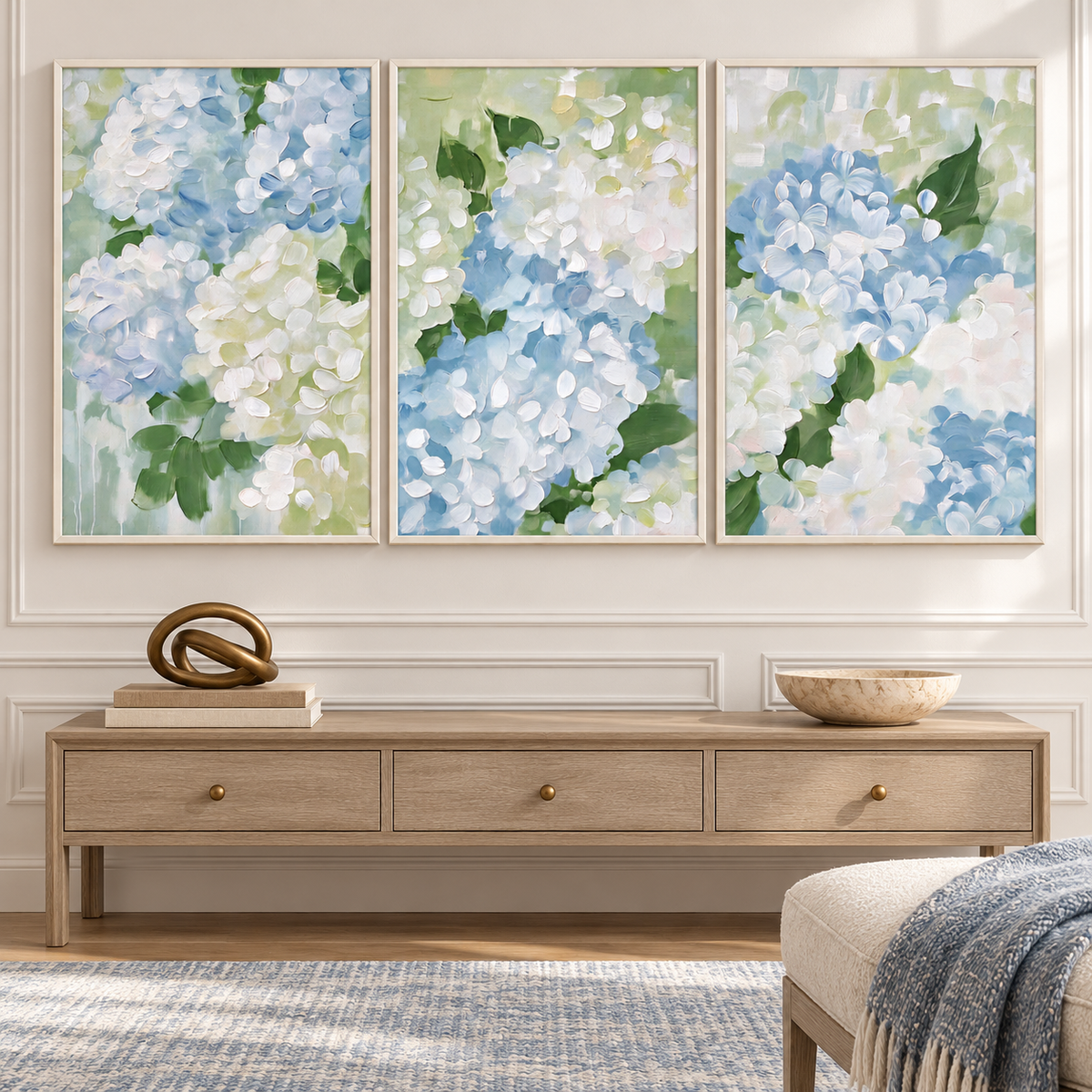 A three-panel hydrangea wall art set with close-up clusters of pale blue and white petals and green leaves spread across three separate vertical panels, in an entryway.