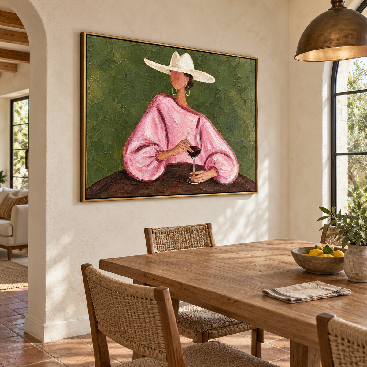 A woman in a loose pink blouse and wide white cowboy hat holding a glass of red wine at a dark table against an olive-green background, shown in room setting 4.