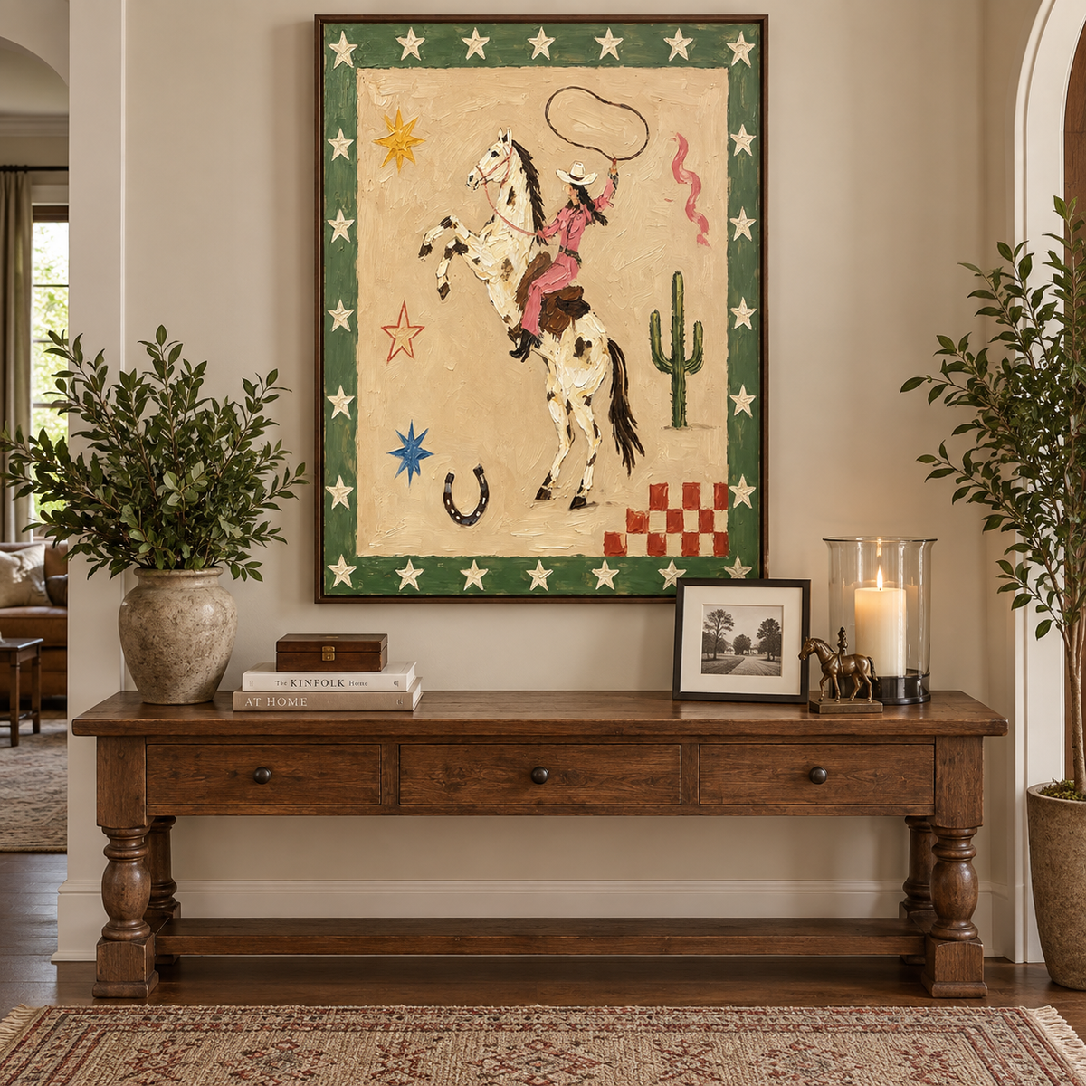 A pink-clad cowgirl swinging a lasso on a rearing spotted horse, surrounded by stars and a cactus, in an entryway.