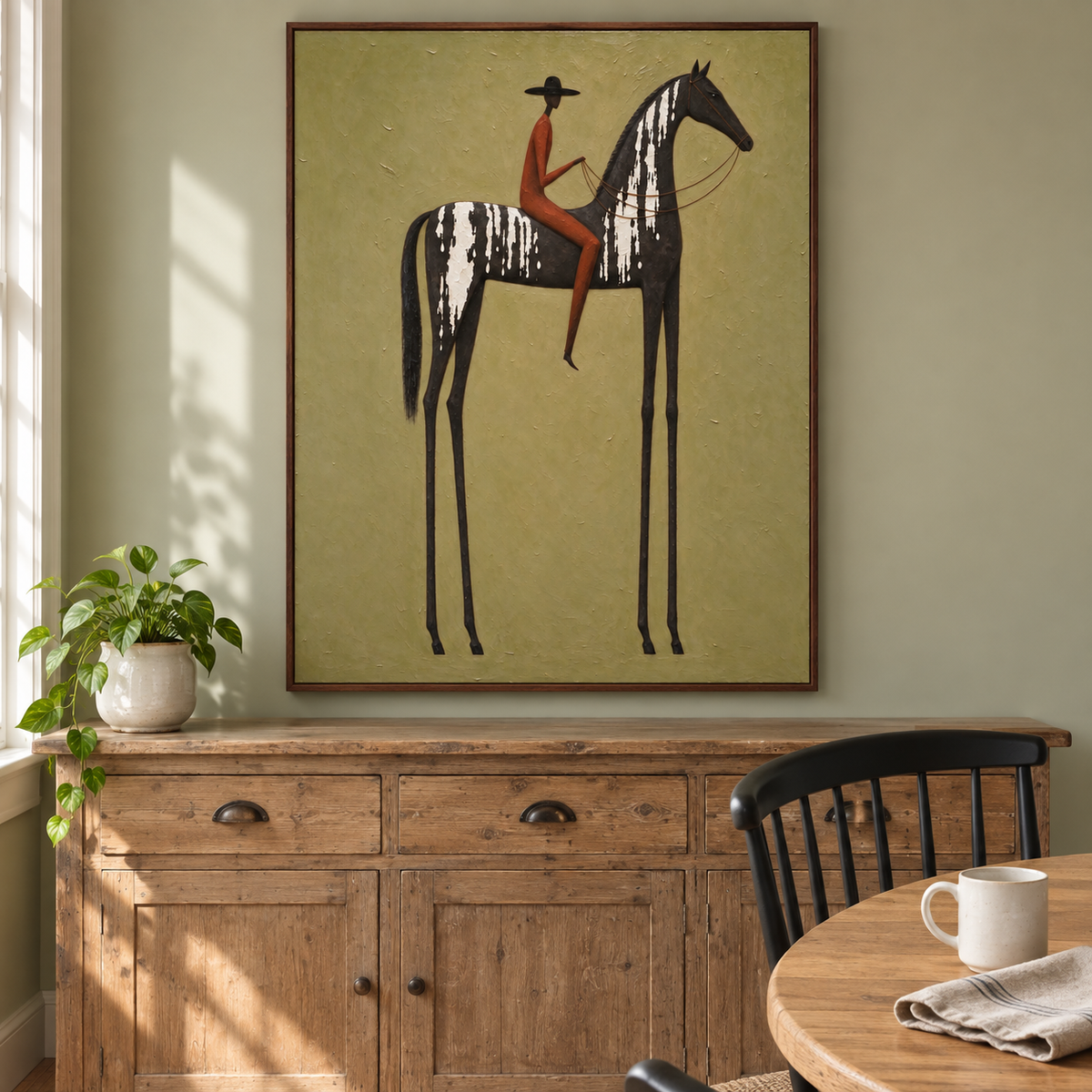 A rust-colored rider in a black hat on a tall narrow black horse with white markings against light olive green, in a farmhouse dining room.