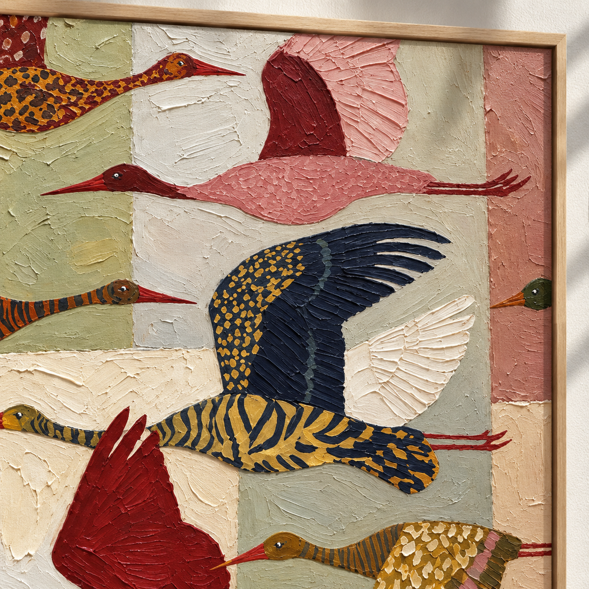 Patterned birds in flight over blocks of mustard yellow, sage green, cream, and dusty pink, close-up of patterned wings.